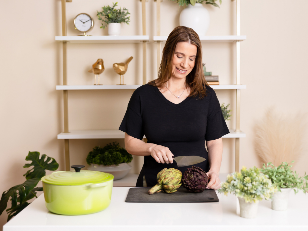 a woman with a kitchen knife works on pre surgical food preparation