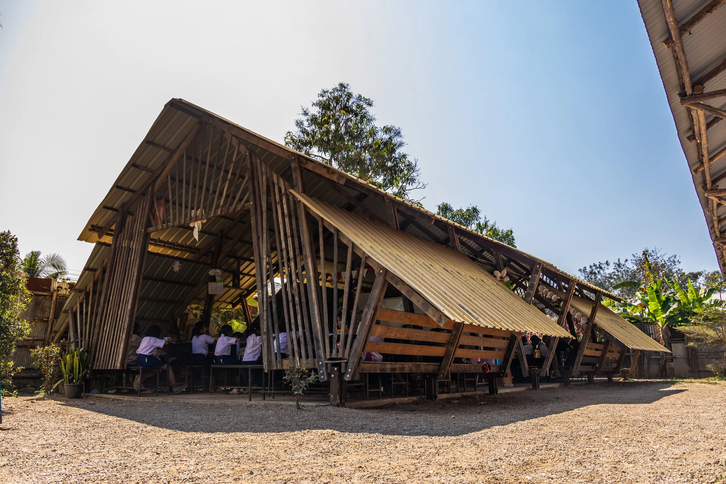 children standing in a circle outside in the sun