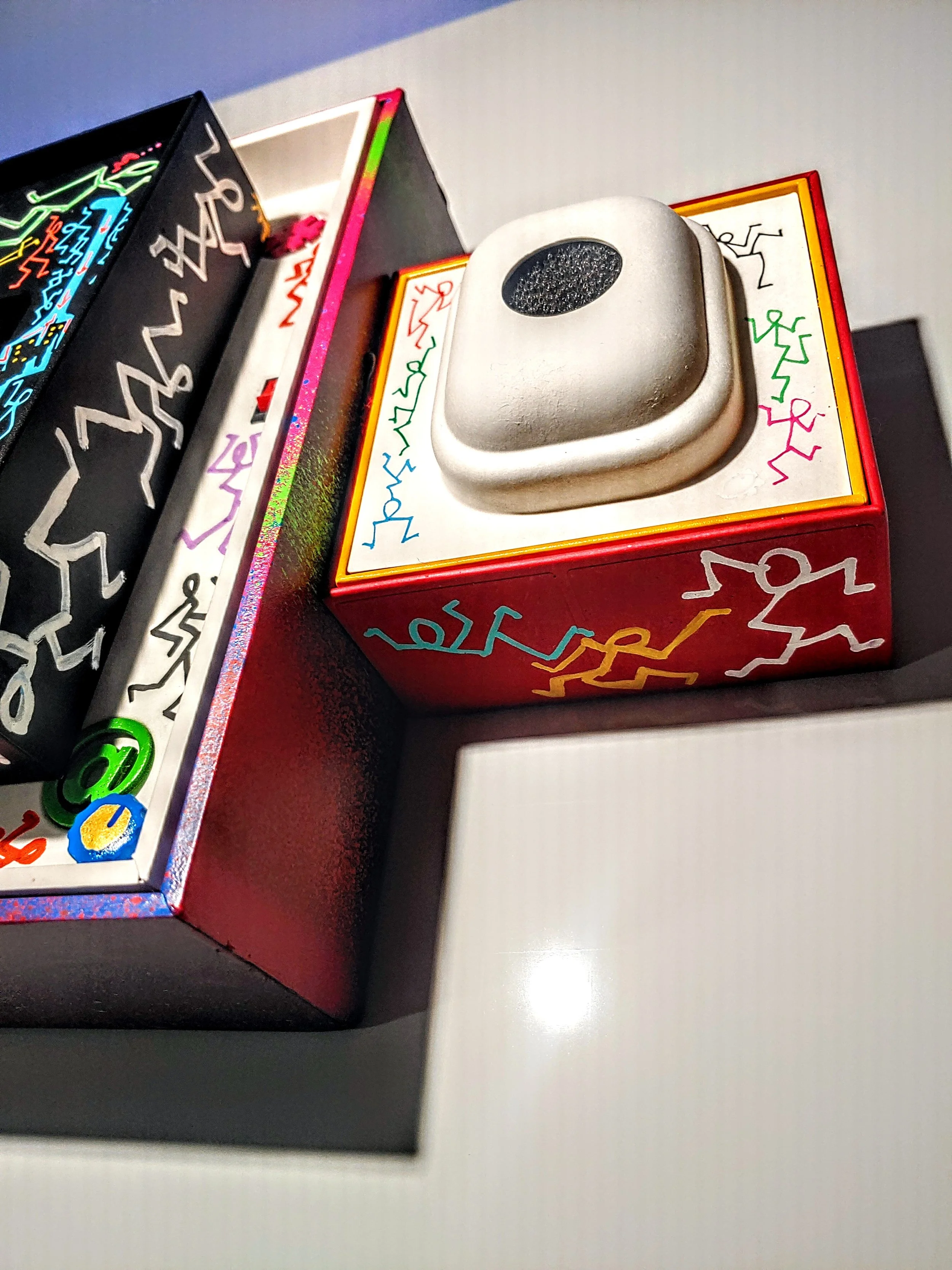 Colorful art piece with abstract figures and a 3D element