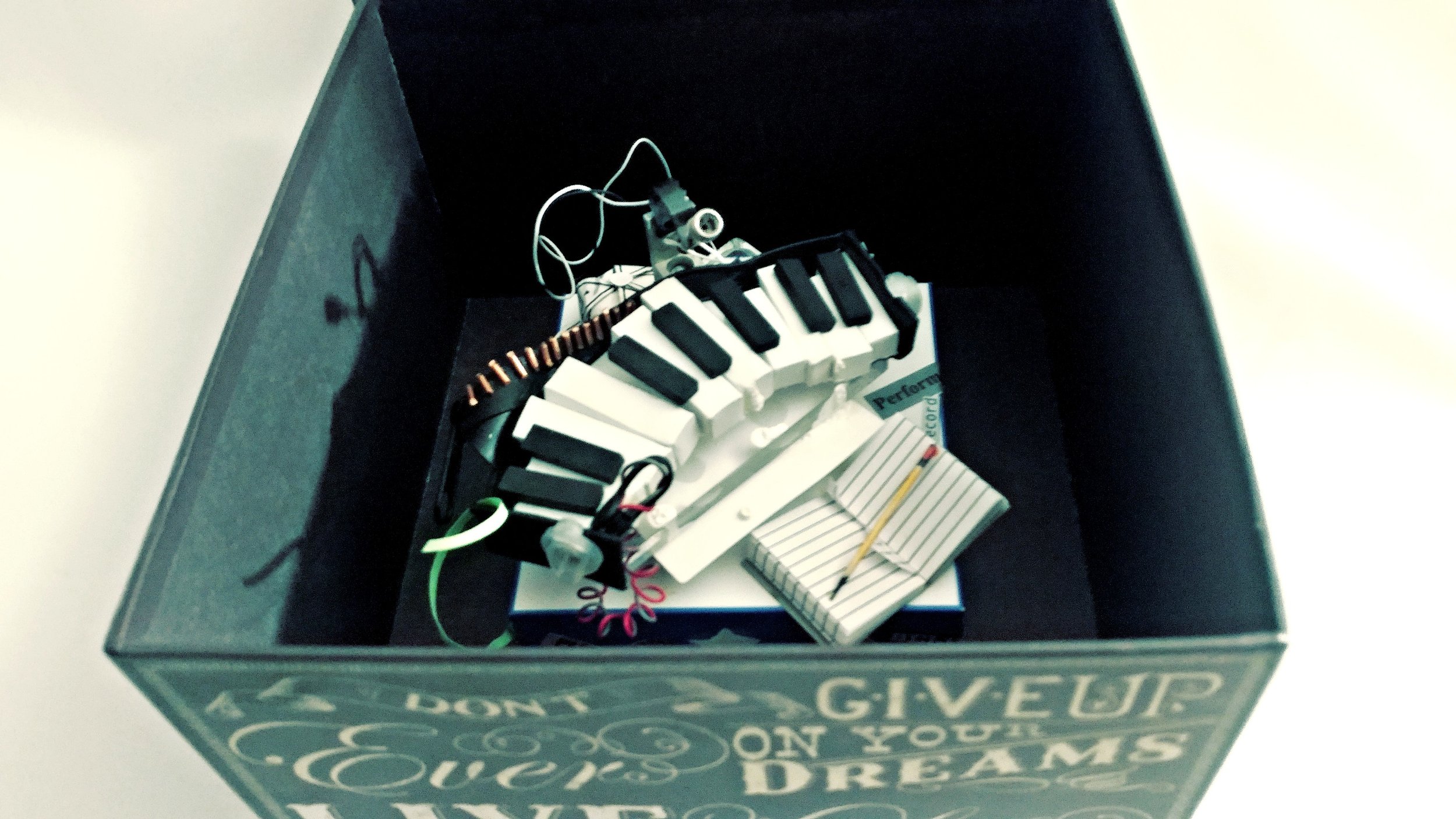 Box with miniature keyboard and assorted items