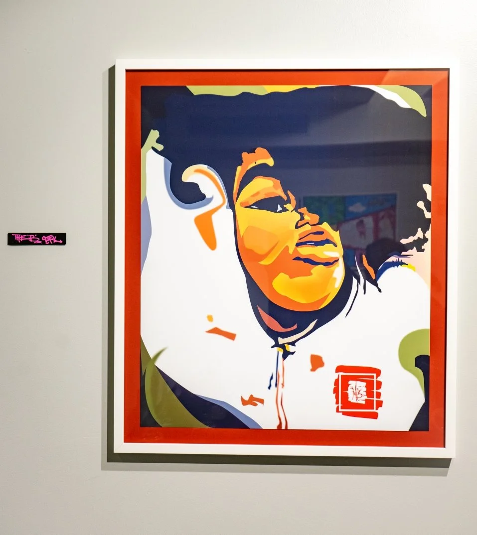 Framed colorful portrait artwork on a wall