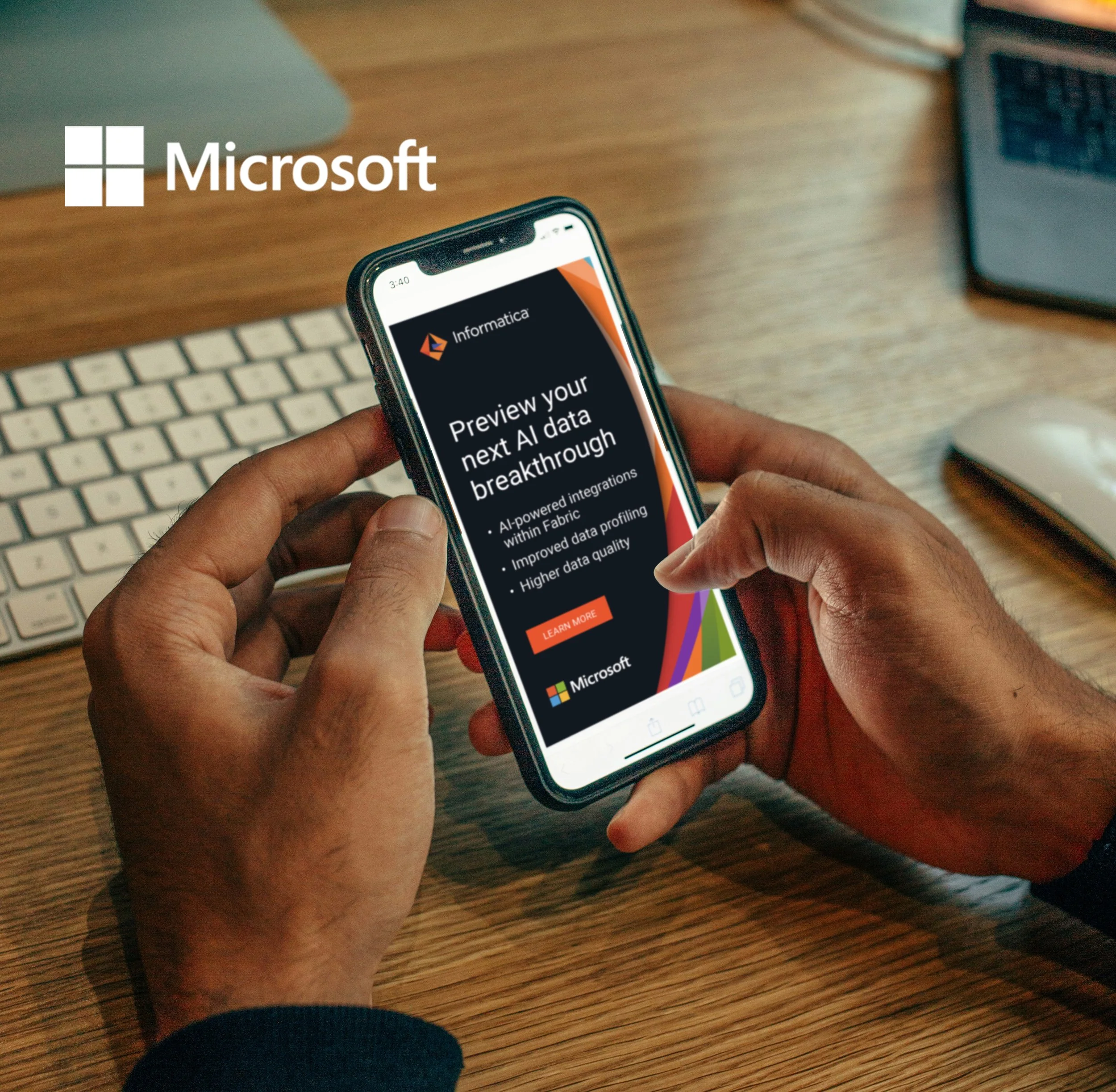 Person holding a smartphone displaying an advertisement for AI data breakthrough preview, with a keyboard and mouse on a wooden desk in the background.