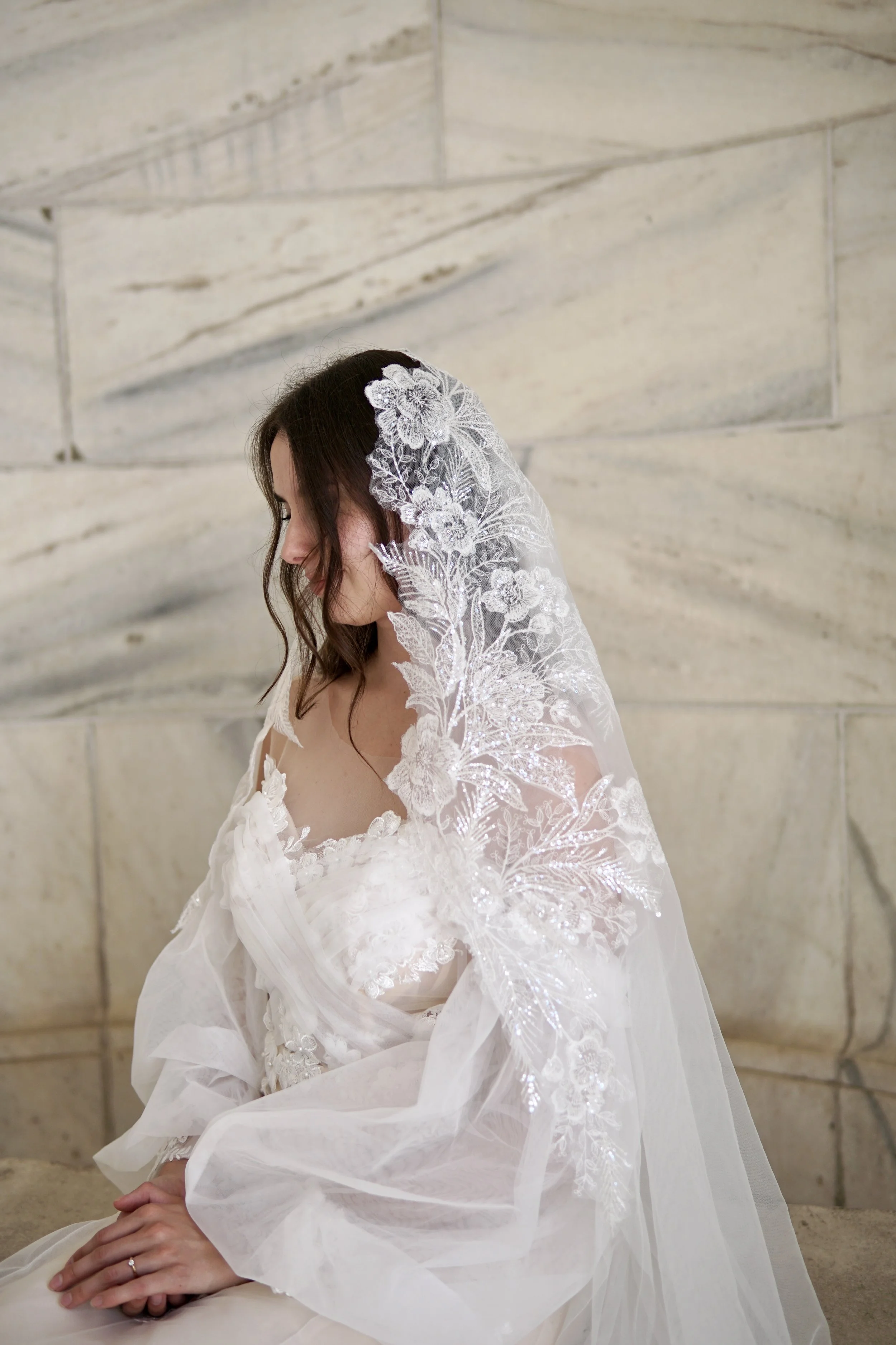 Bride wearing a sequins floral lace mantilla style veil