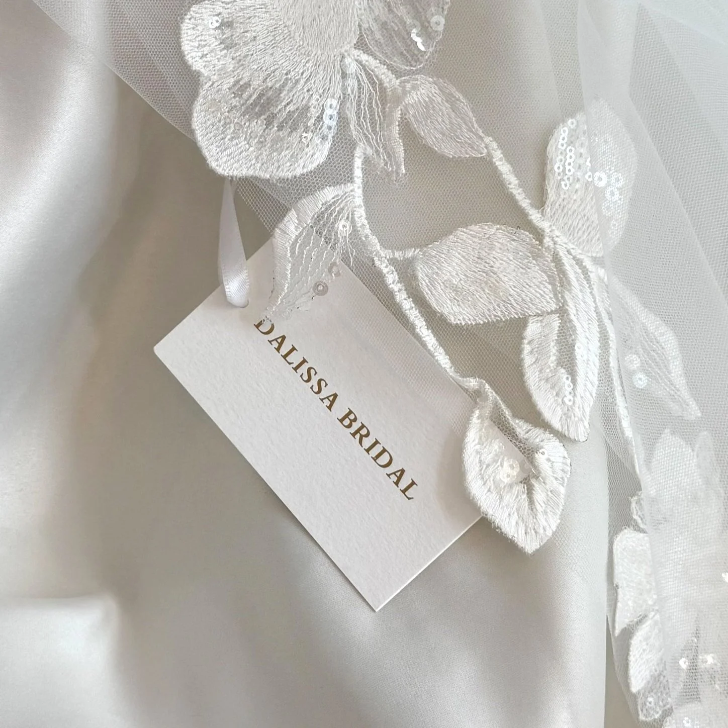 The picture shows a floral lace applique and a "Dalissa Bridal" tag (Copy)