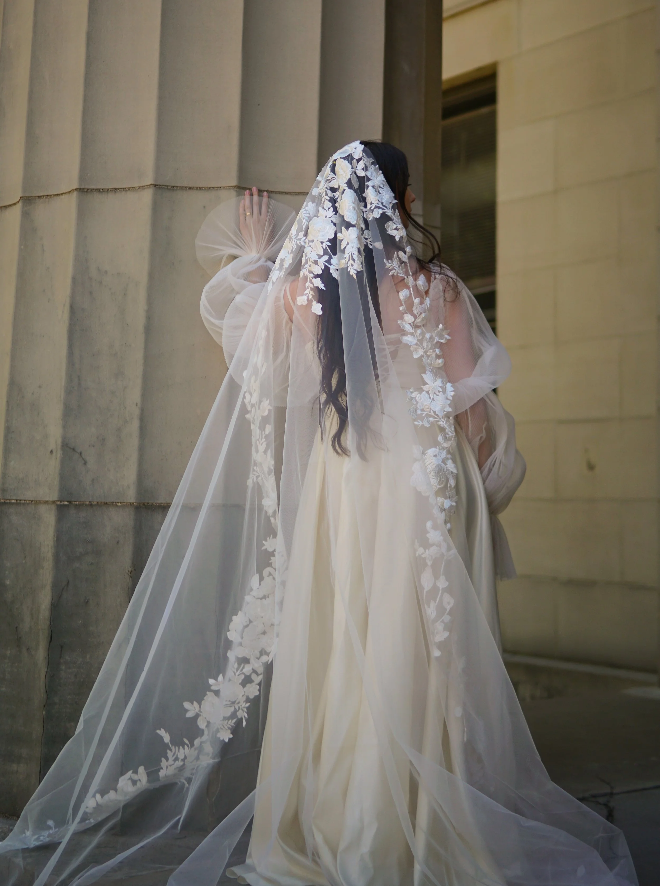 Bride wearing a full lace mantilla floral lace veil with mix of small and bigger flowers