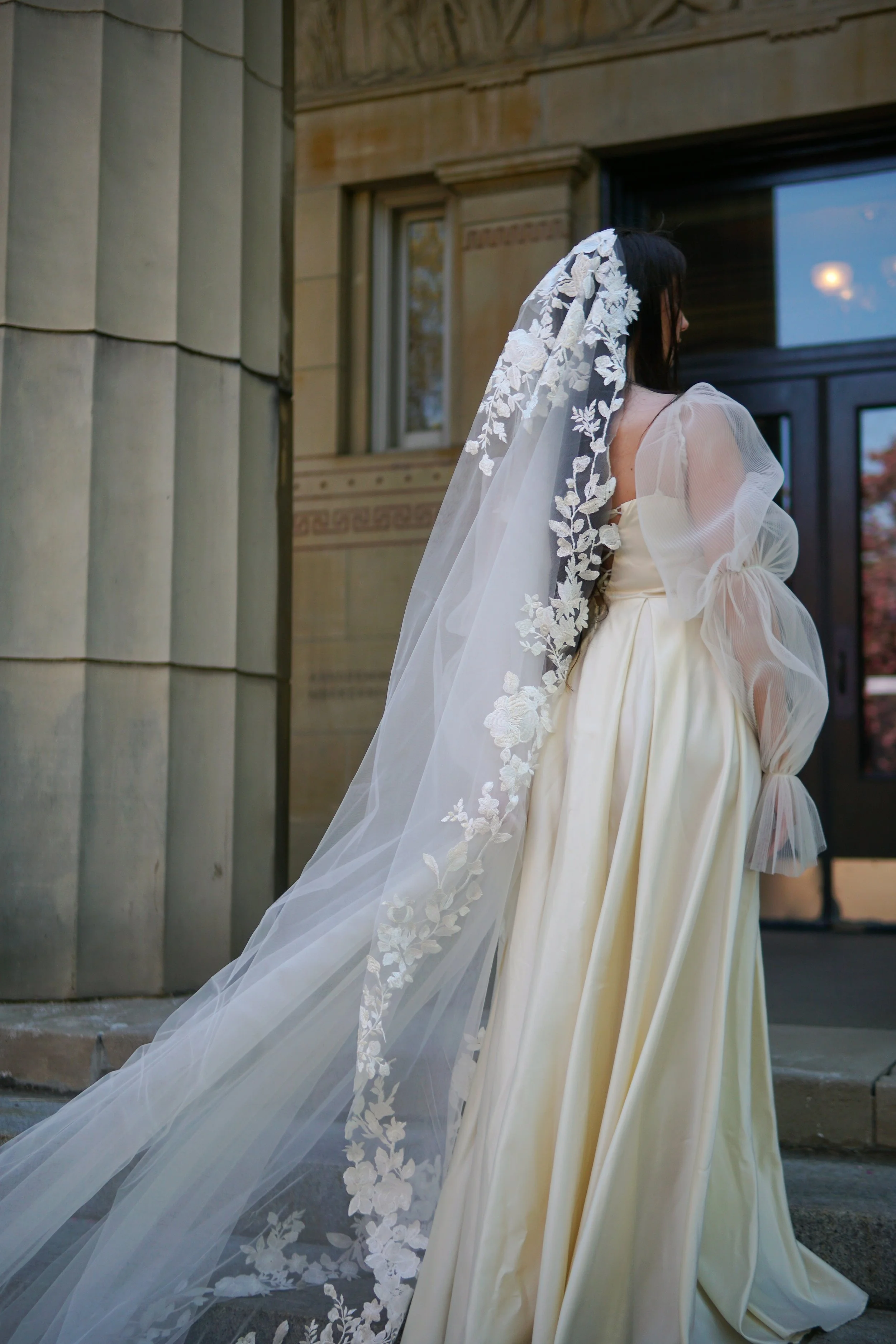 picture of the Bride wearing a full lace mantilla floral lace veil with mix of small and bigger flowers