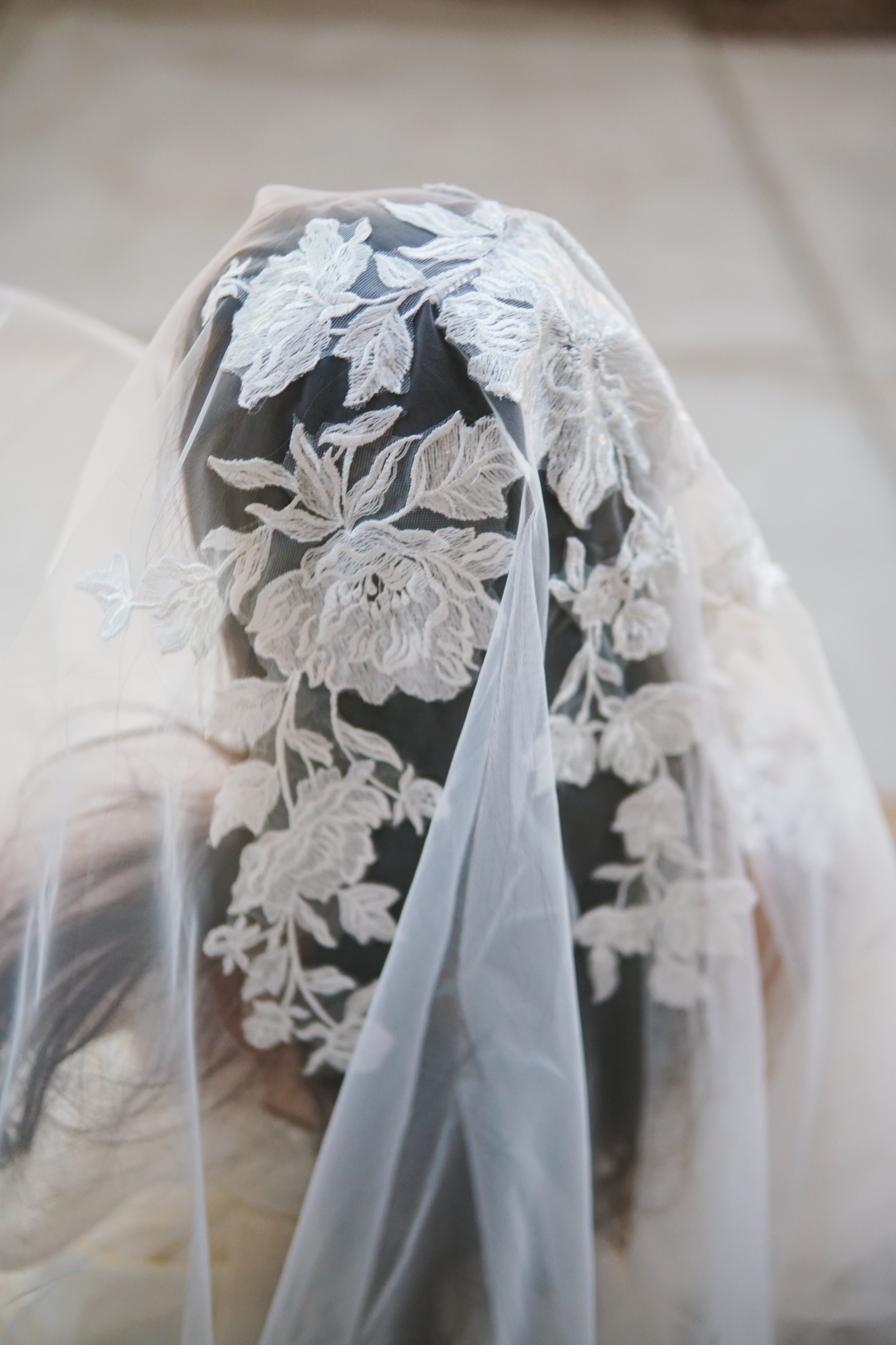 Close picture of the floral lace veil on  the entire head area with flowers and branches