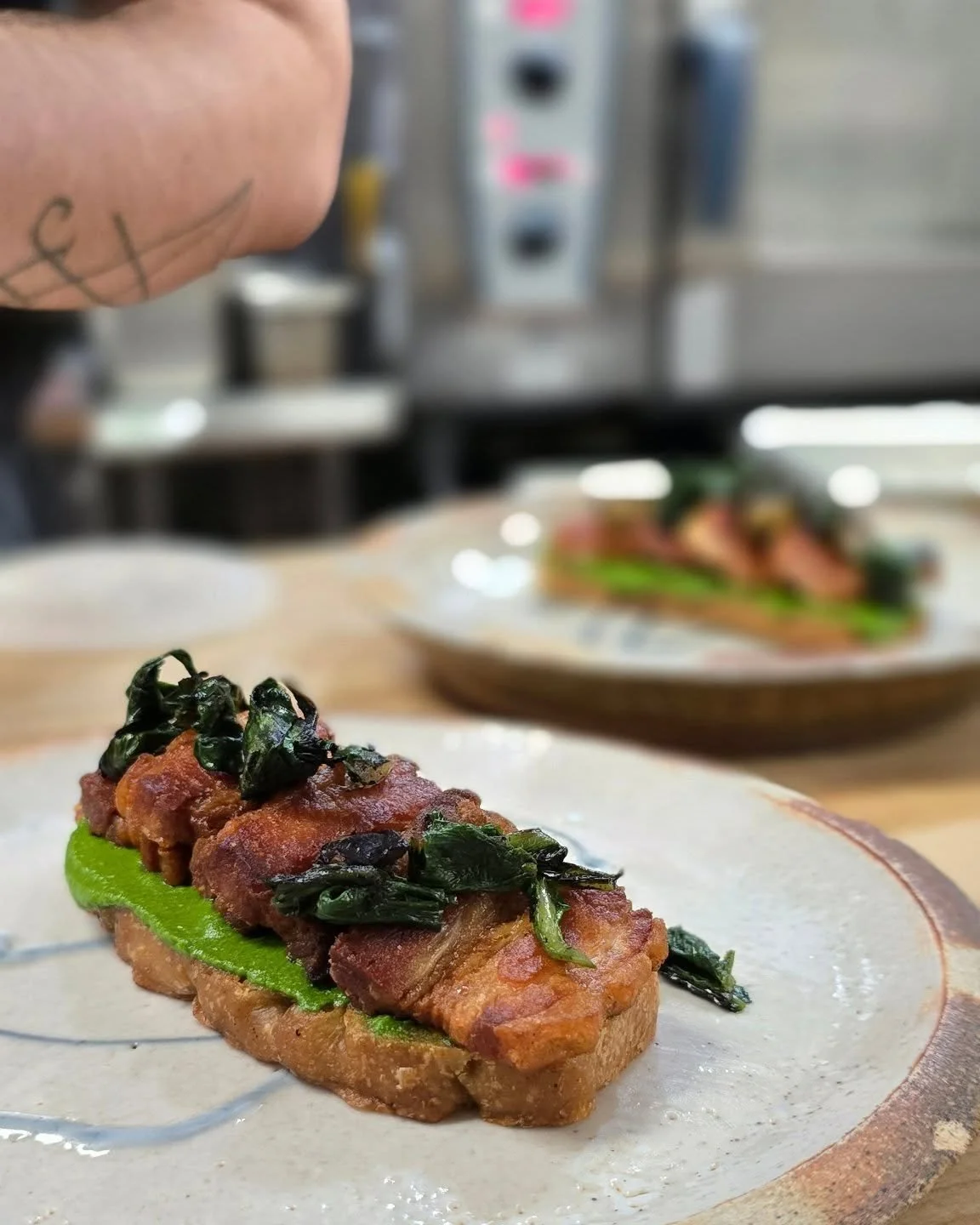 It's Tuesday, and we're starting the week off right with this crispy pork belly toast! Served on our famous sourdough focaccia, with arugula pesto and charred ramps. Don't miss out!!