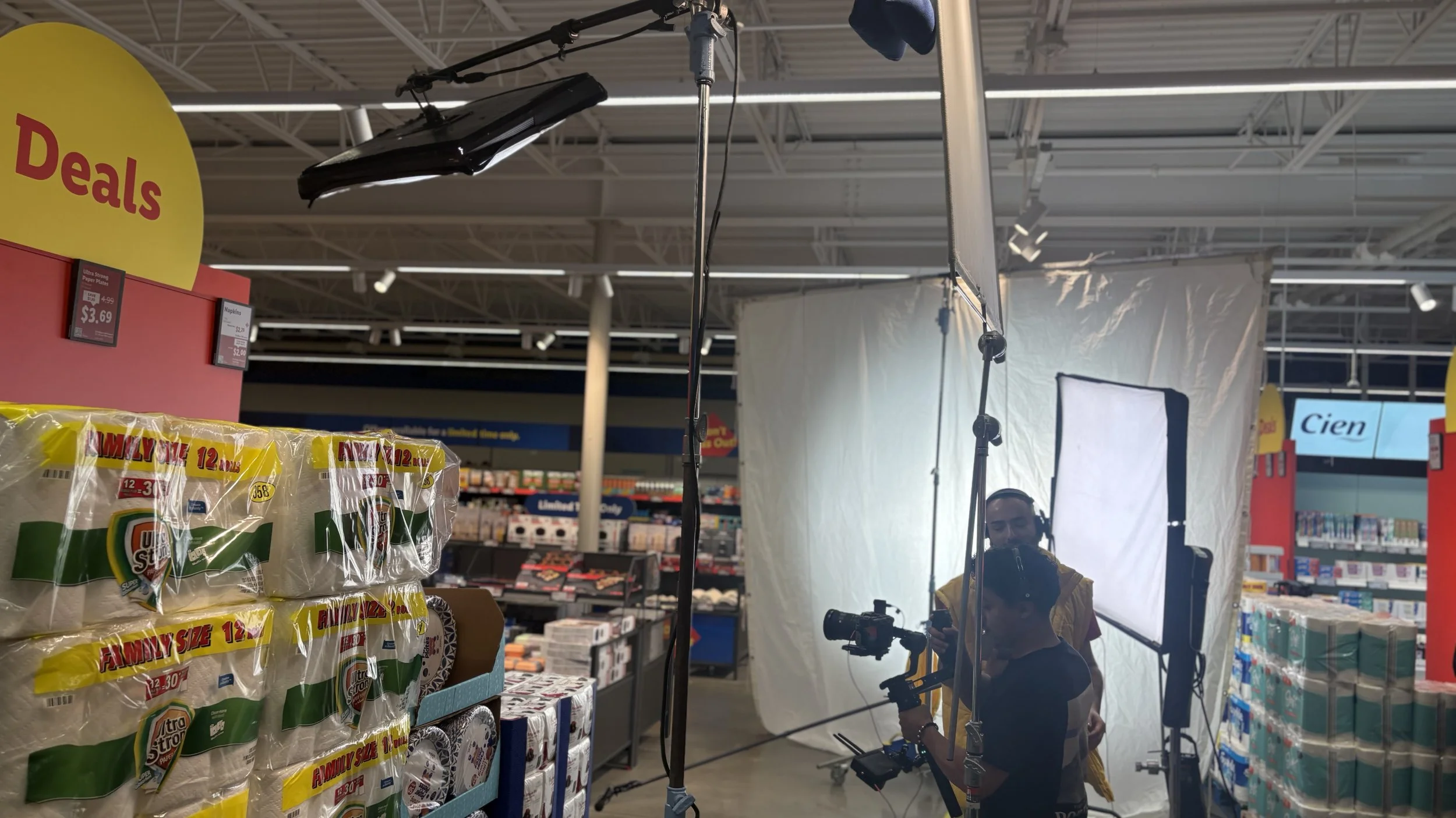 Lidl Commercial: Grip Work
A professional video recording setup in a store aisle, with lighting equipment, a backdrop, and a person wearing a yellow vest preparing to record.