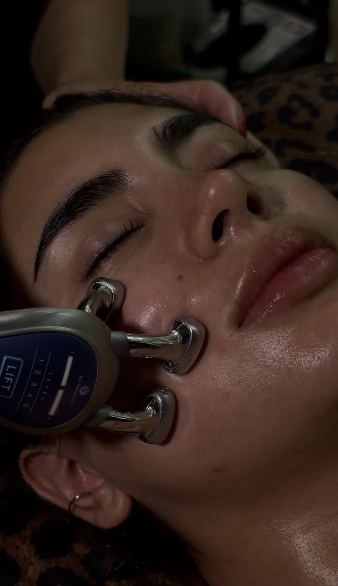 Client relaxing during a facial treatment at The Rejuv Room in San Diego