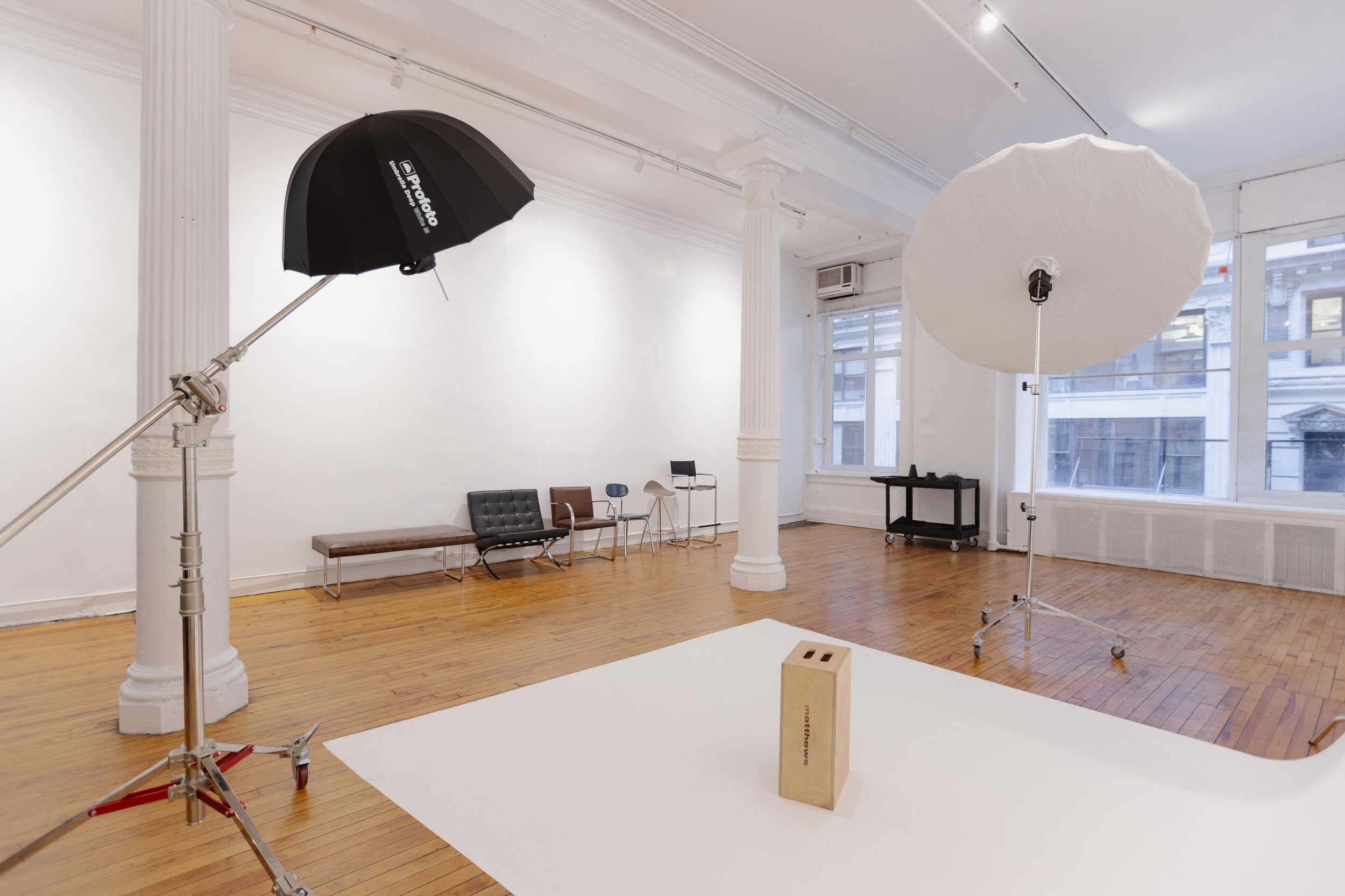 Multilevel production studio in Midtown Manhattan with high ceilings, artistic backdrop walls, large windows, and a fully equipped shoot-ready setup.