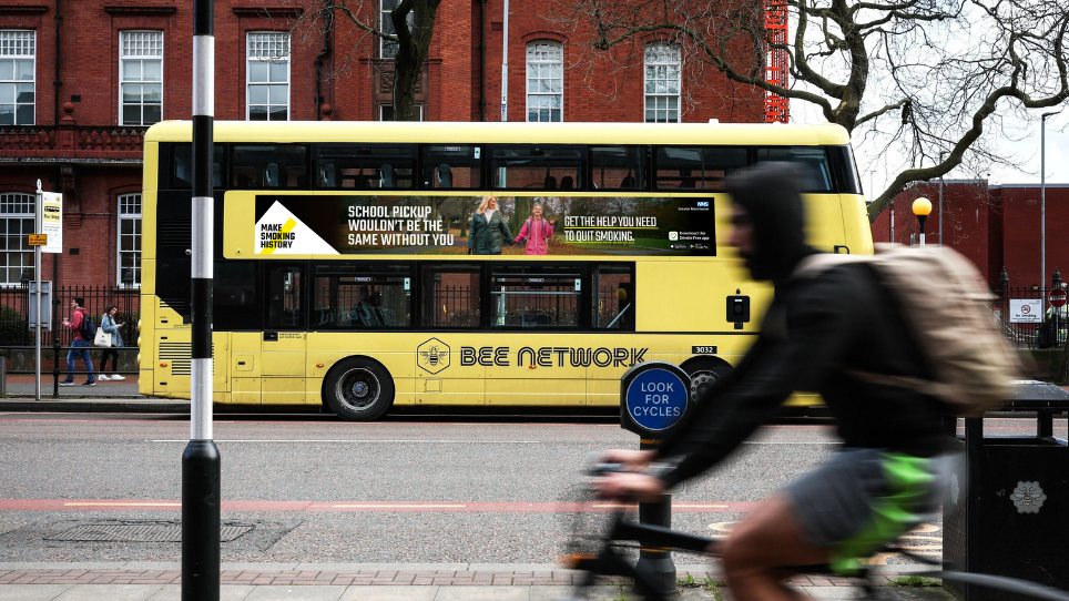 image of bus with banner showing advert of stop smoking campaign