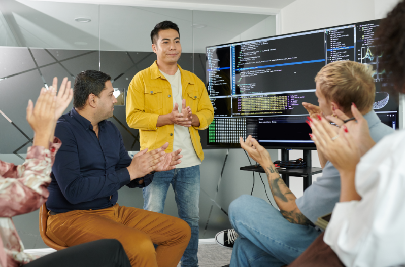 Startup team pitching ideas to others during a fast-paced workshop exercise.