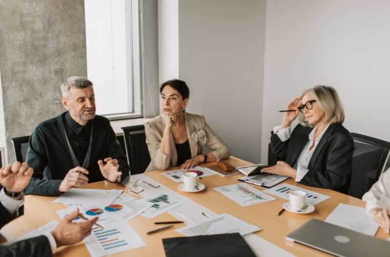 Team meeting with participants discussing but not reaching a clear decision.