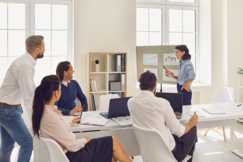 Team discussion in a workplace setting, representing learning and behaviour development.