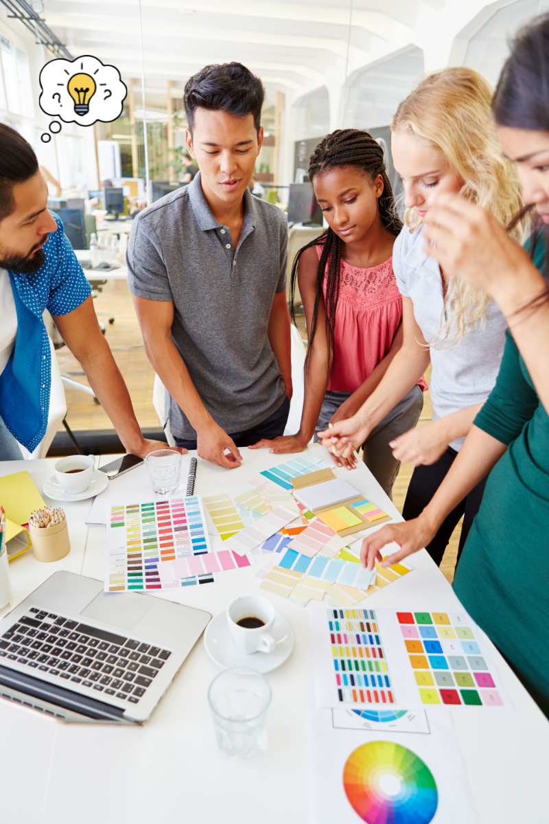 UK startup team collaborating around a table to work through ideas and problem-solving tasks.