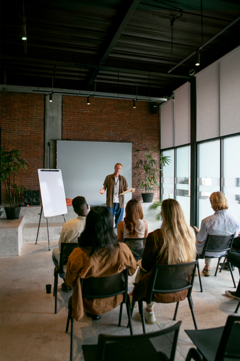 Trainer presenting to a seated group during a workshop.