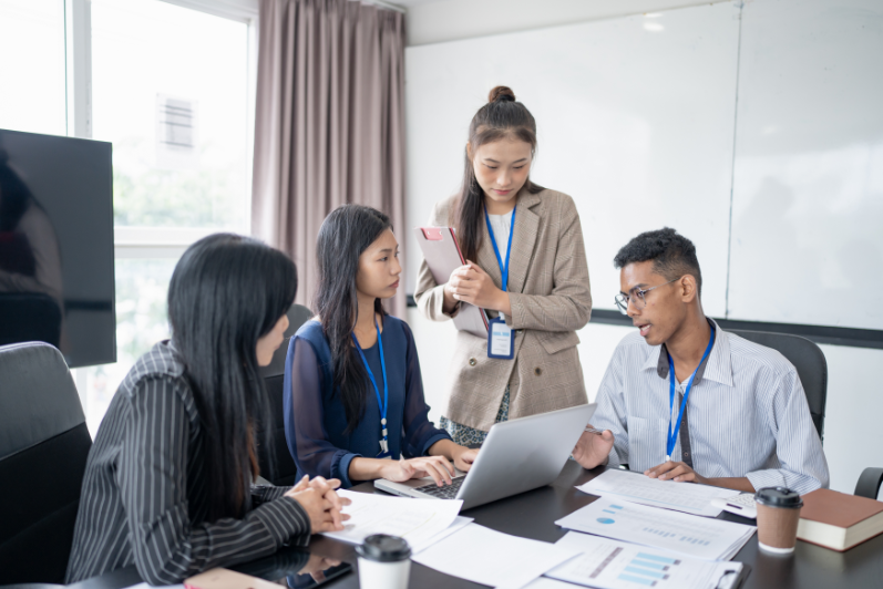 Workplace team discussion representing key behavioural skills.