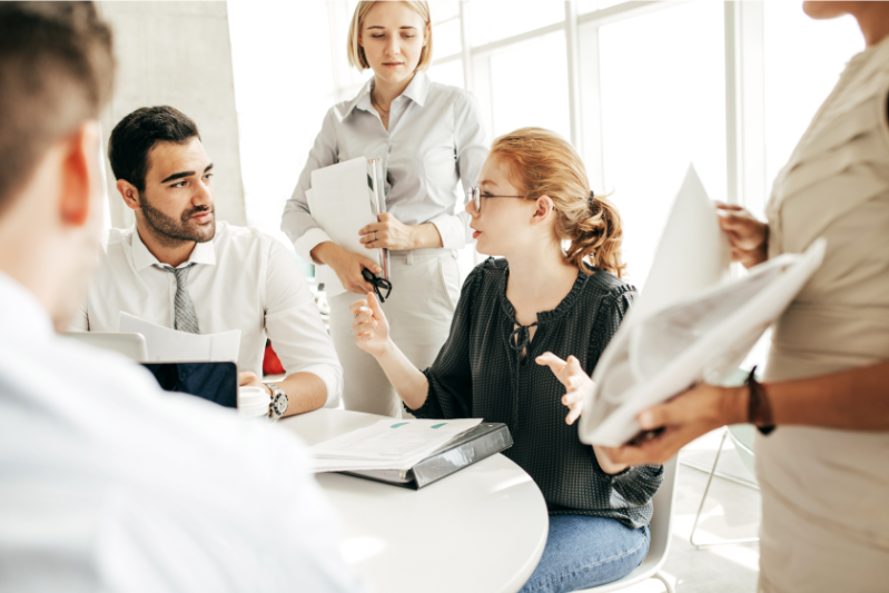 Team facing a time sensitive decision, showing hesitation under pressure.