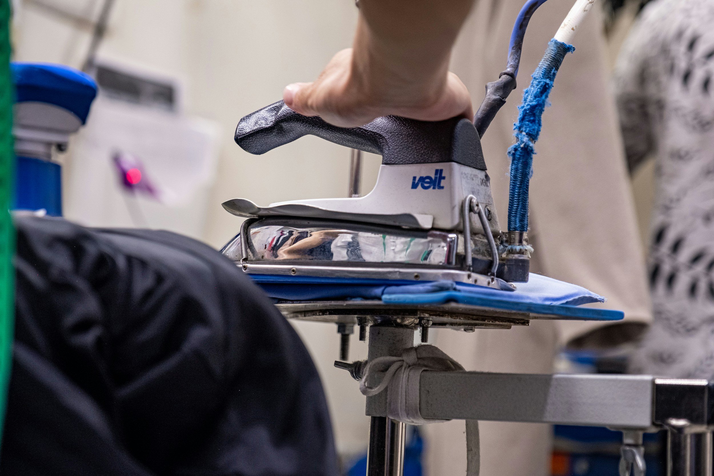 Professional steam iron pressing a garment