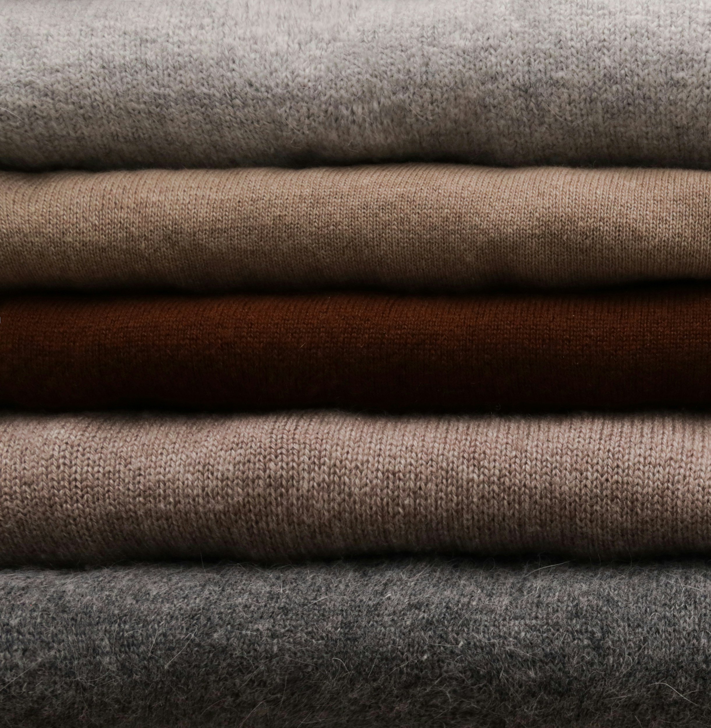 A stack of folded wool and cashmere jumpers