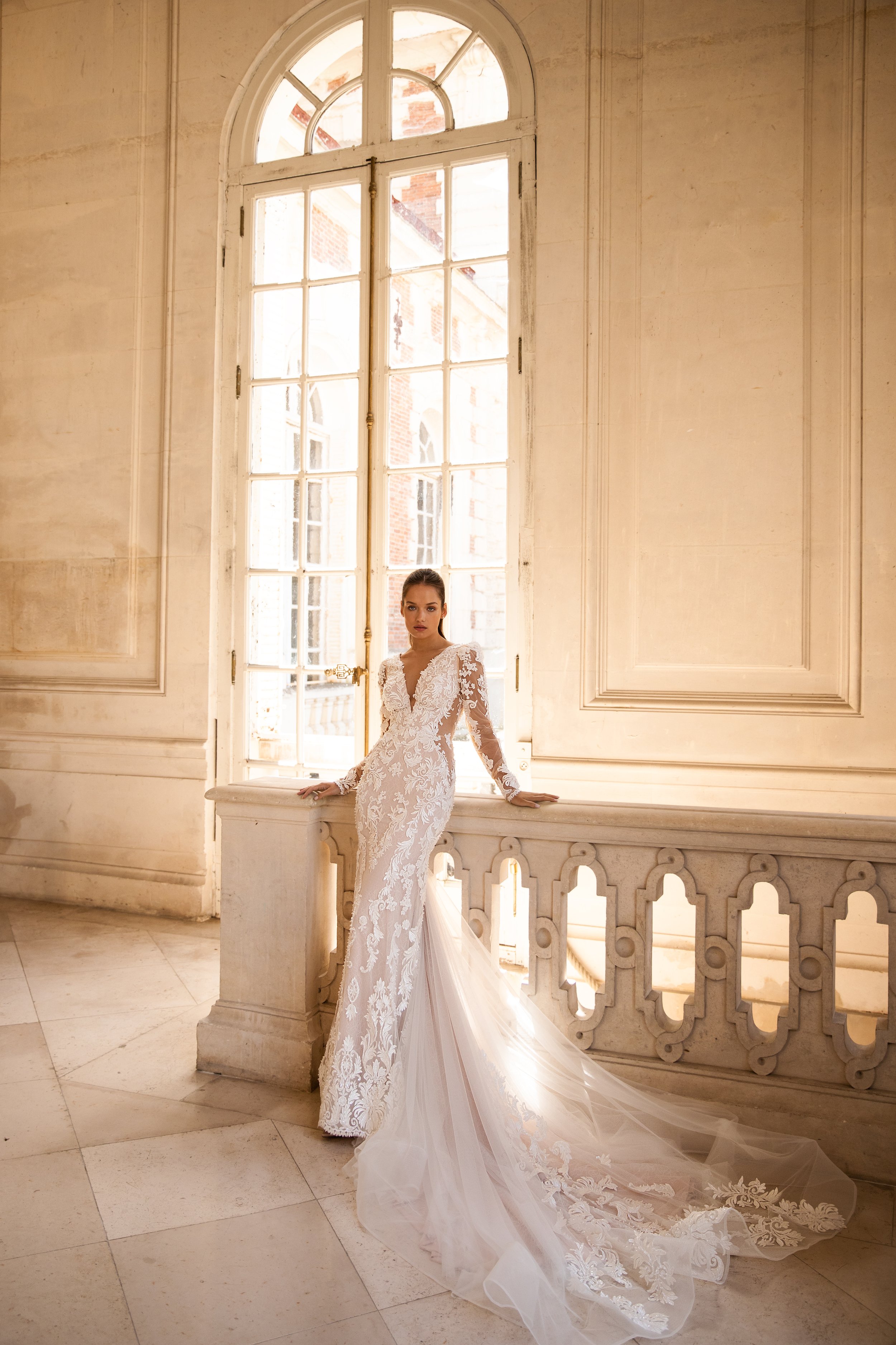 Bride in a lace wedding dress with a long train, after professional wedding dress cleaning