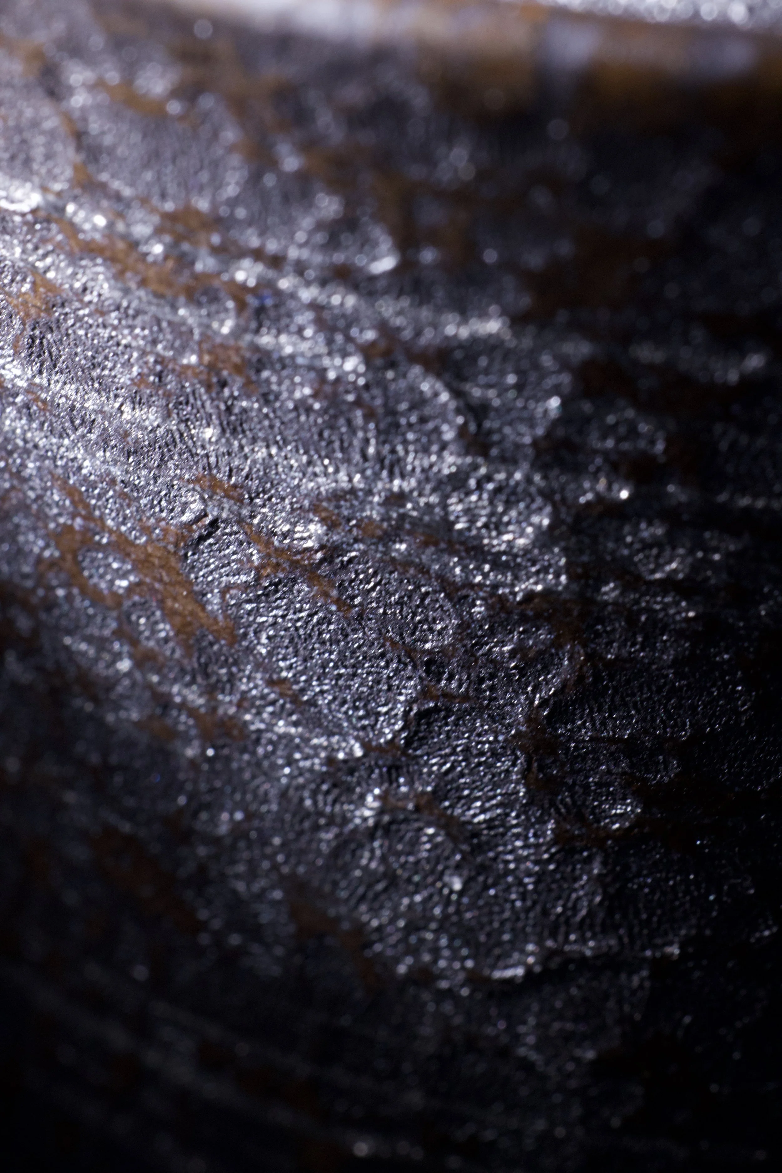 Study of ceramic surface and material.

Light reveals the irregular texture and layered glaze,
bringing out depth, density, and subtle variations across the surface.

A close observation of how material holds light.