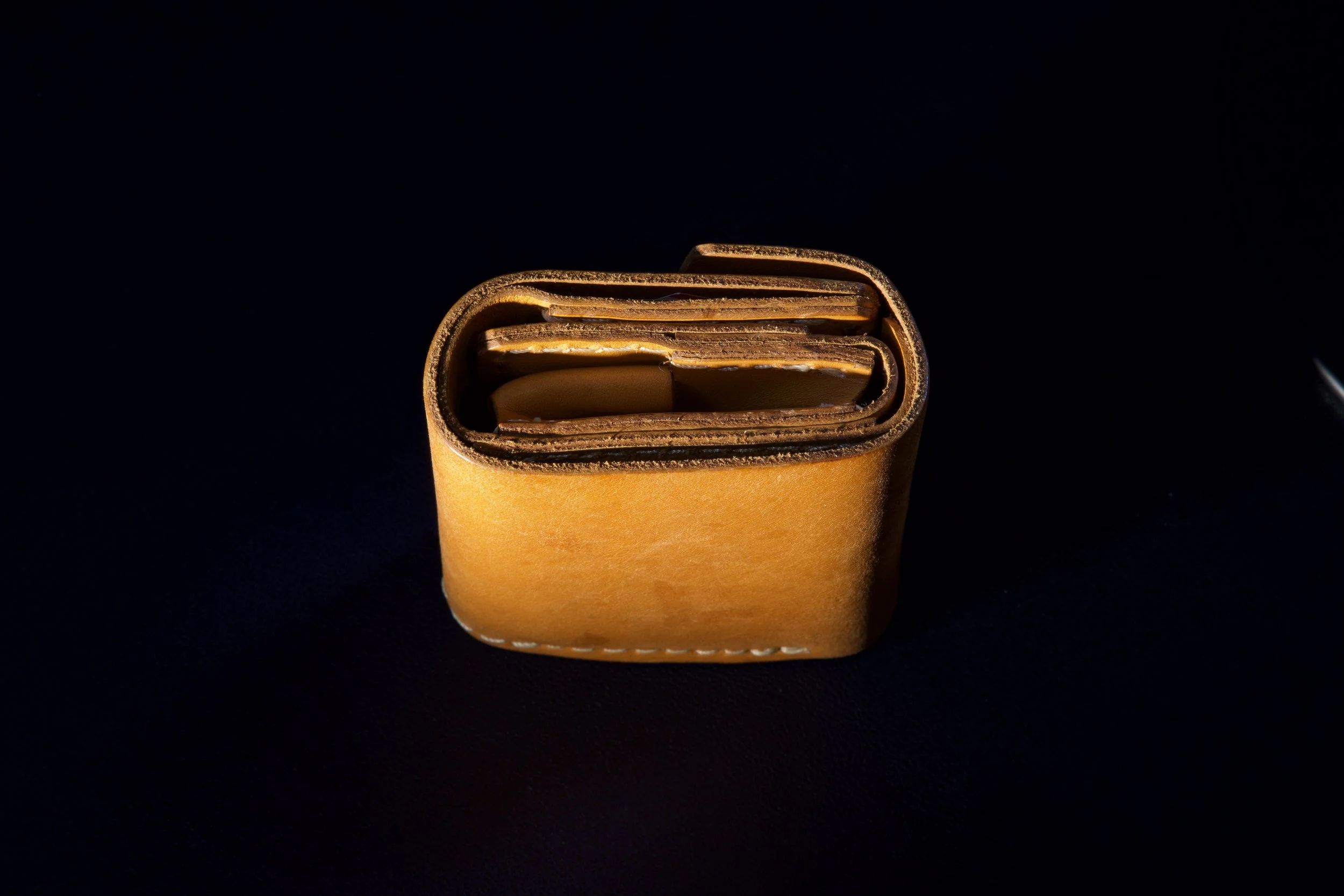 Leather wallet product photography with controlled light and shadow