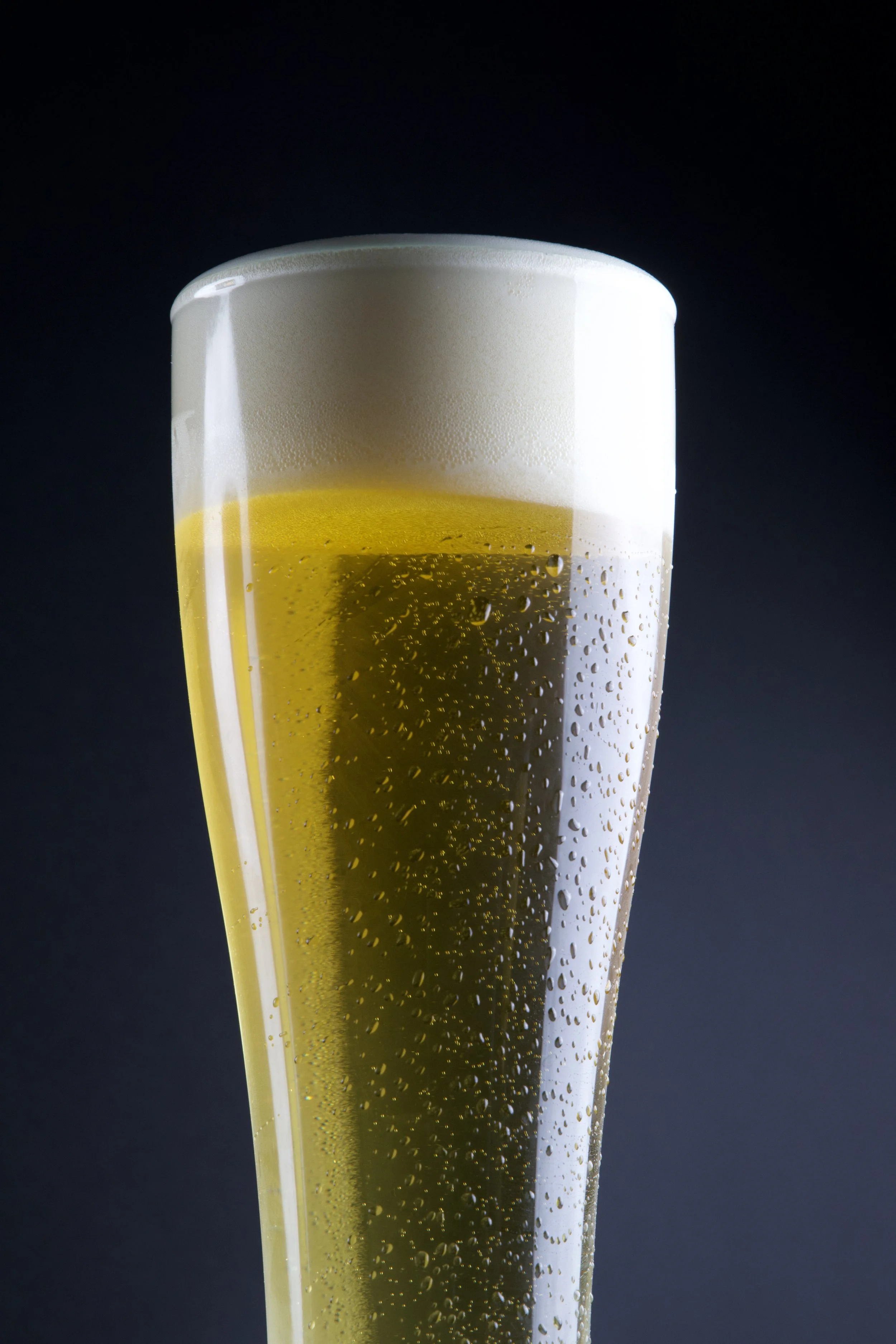 Beverage product photography with dramatic lighting and condensation detail.