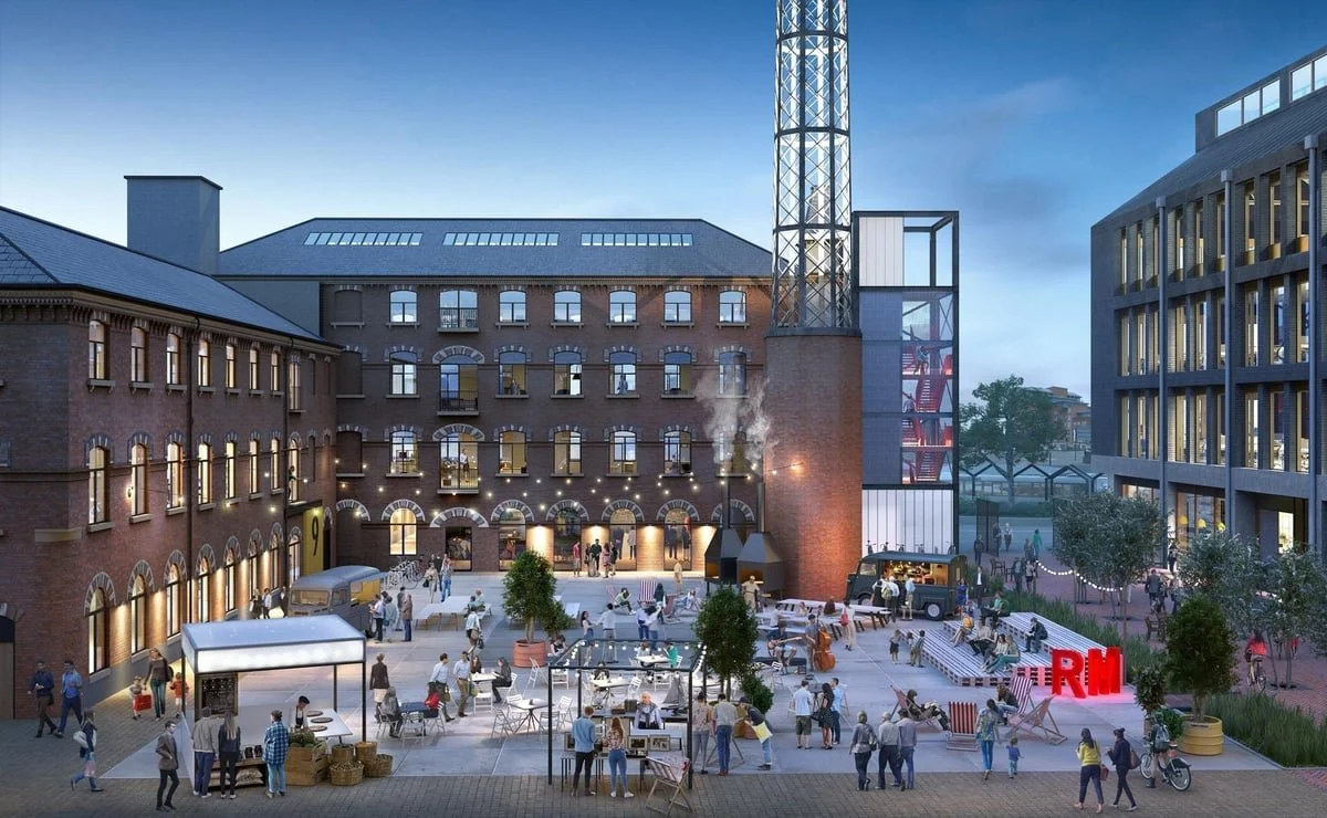 Rutland Mill, Wakefield, with lighting and greenery enhancing the ambiance. Food stalls and seating areas are visible, with a sign reading "RM" illuminated in red.
