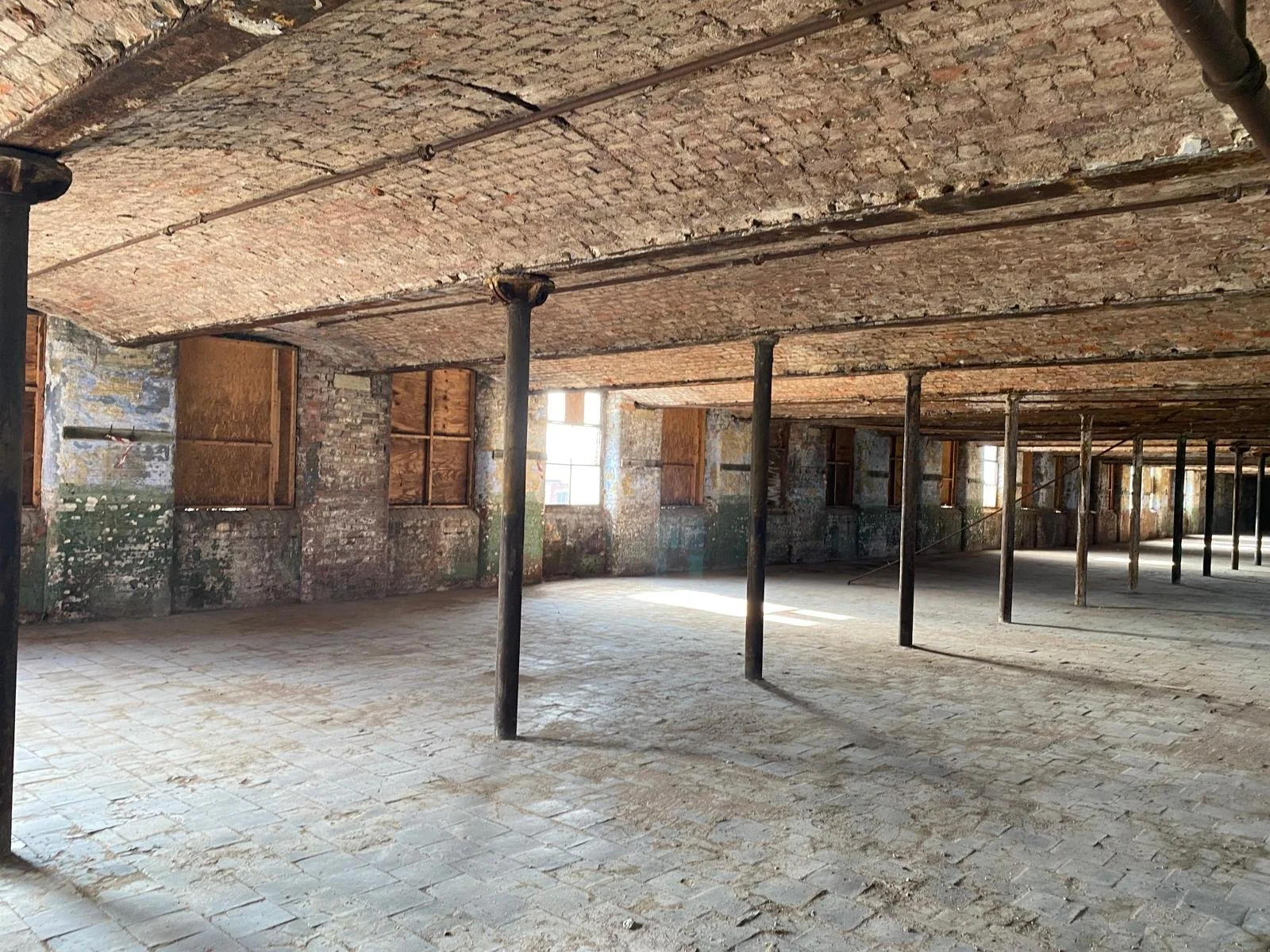 Brunswick Mill, Ancoats, Manchester, interior with brick walls, wooden beams, and columns