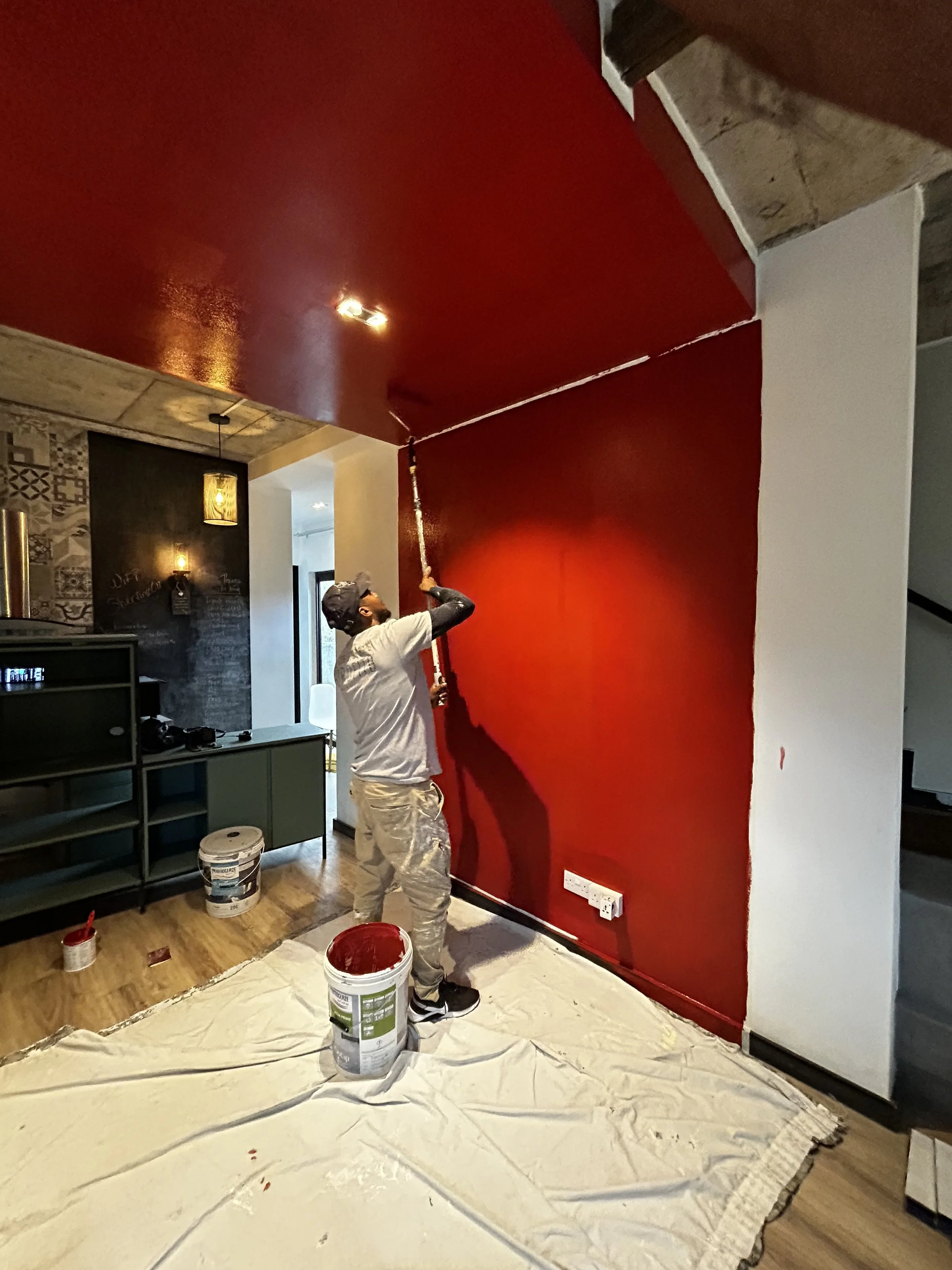 An image of the use or bold paints in tiny space: Rouz Sali, a color representing the rich culture of Mauritius having red floors in colonial houses in the 1950s.