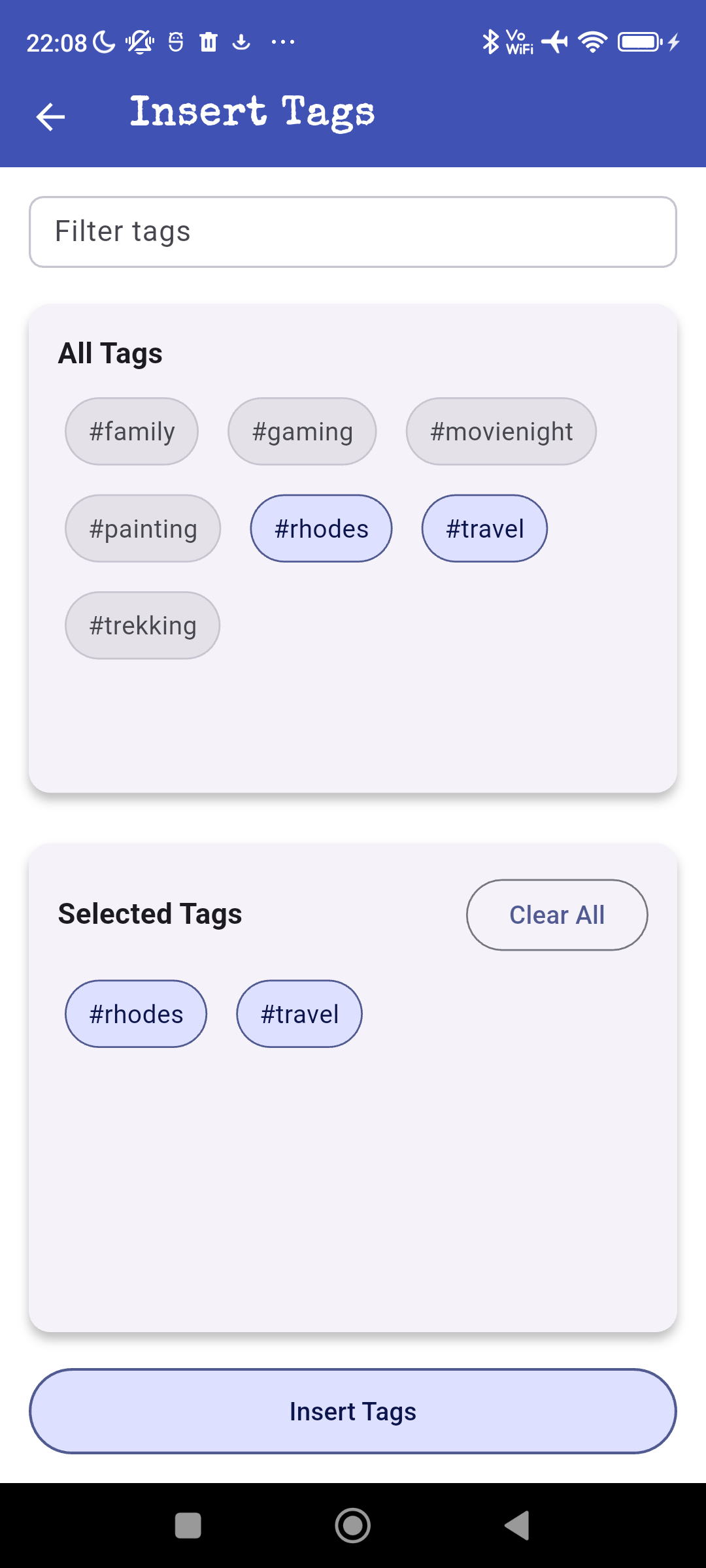 Mobile app screen showing tag insertion options with tags such as #family, #gaming, #movienight, #painting, #rhodes, #travel, #trekking; Rhodes and travel tags are selected for insertion.