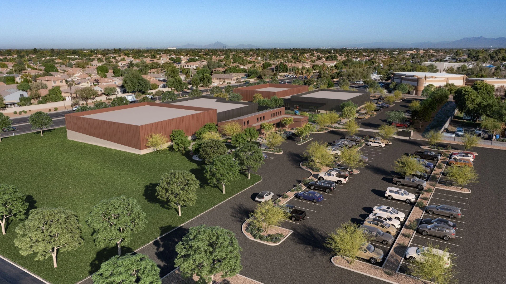 Computer generated image of new building with grass field and parking lot