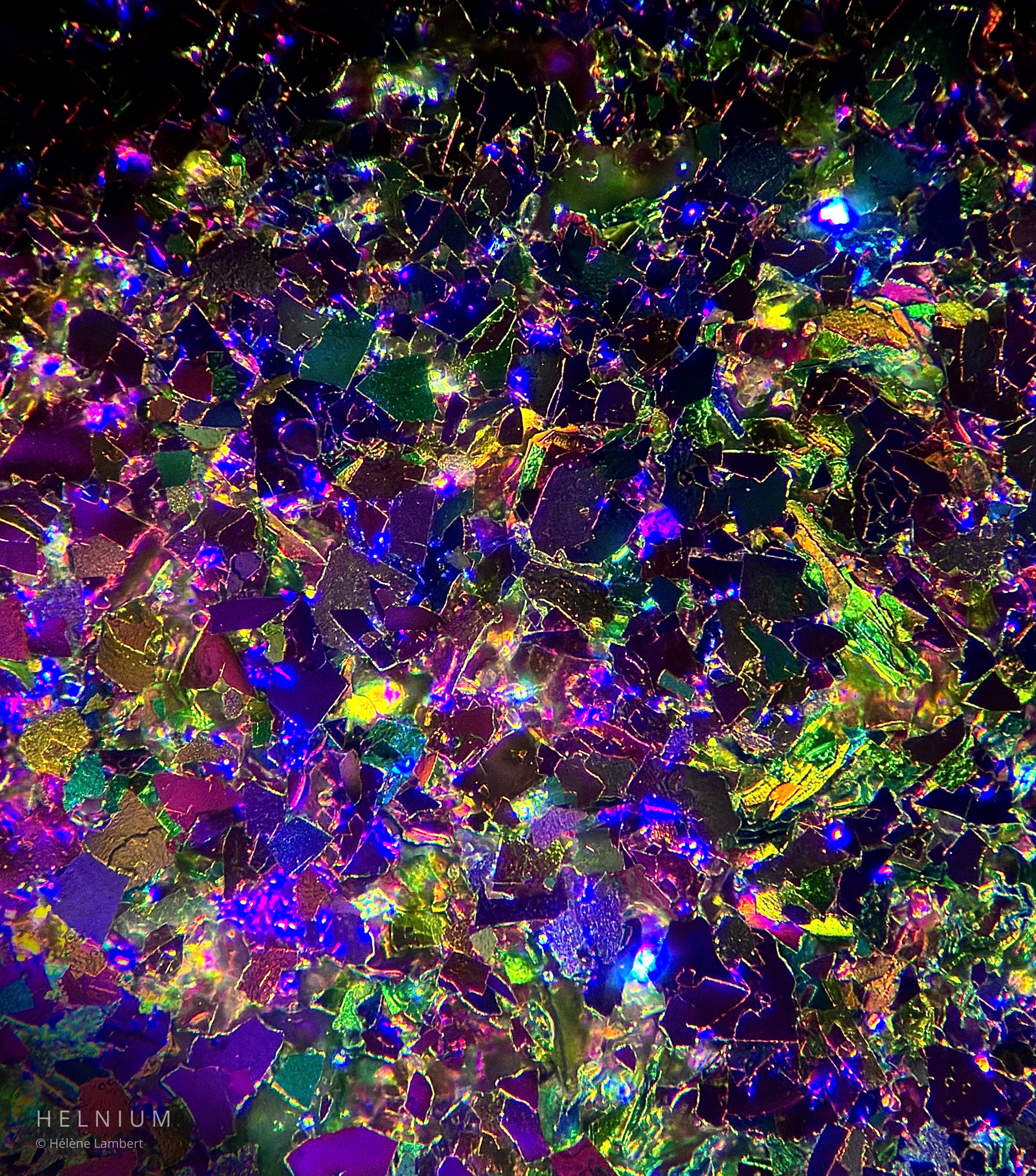 Galaxy eyeshadow makeup under the microscope, revealing colorful reflective pigments and microscopic structures resembling a galaxy. Helnium.