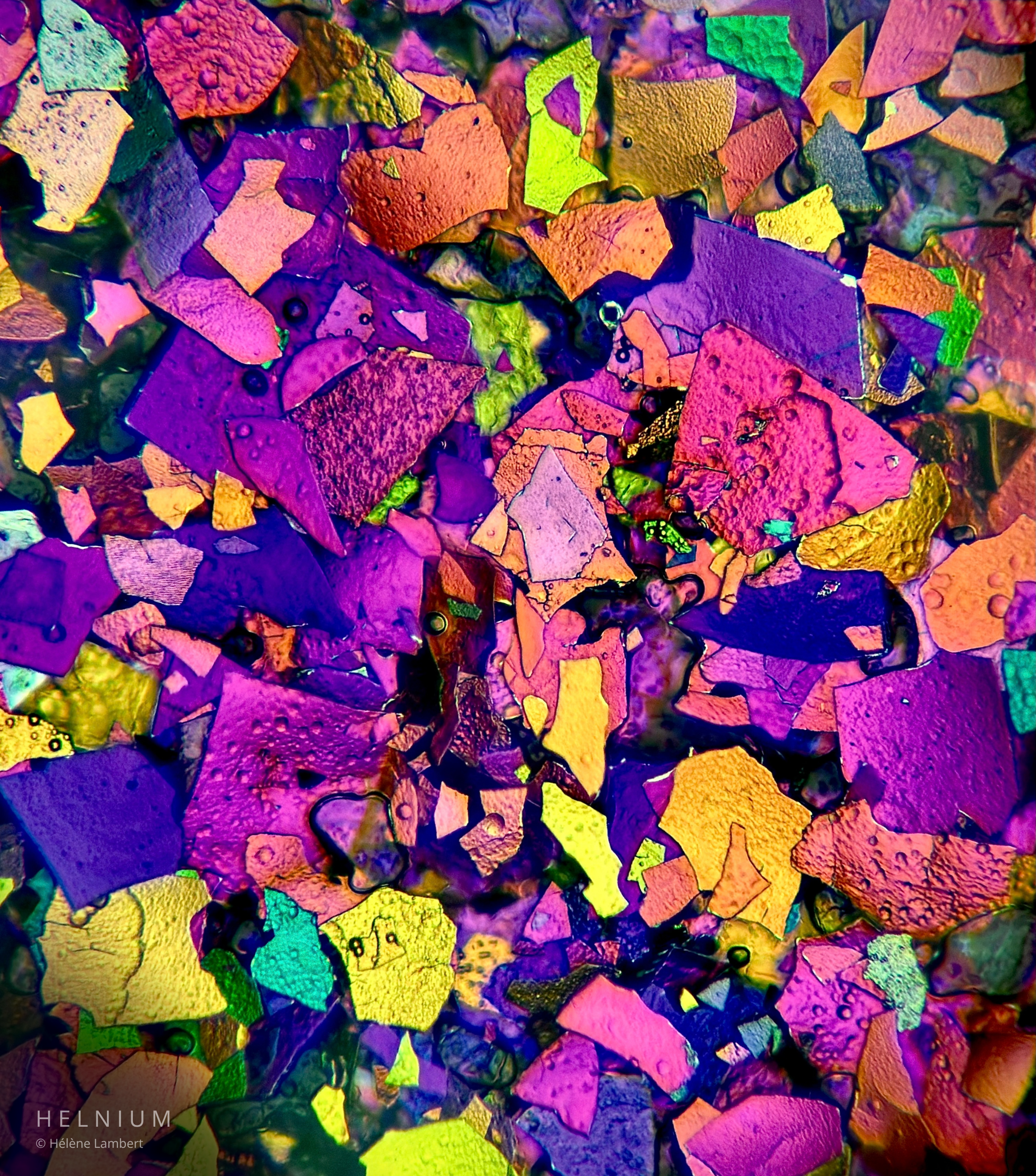Eyeshadow makeup observed under a microscope, revealing pigment particles and microscopic cosmetic structures. Helnium Scientific Design.
