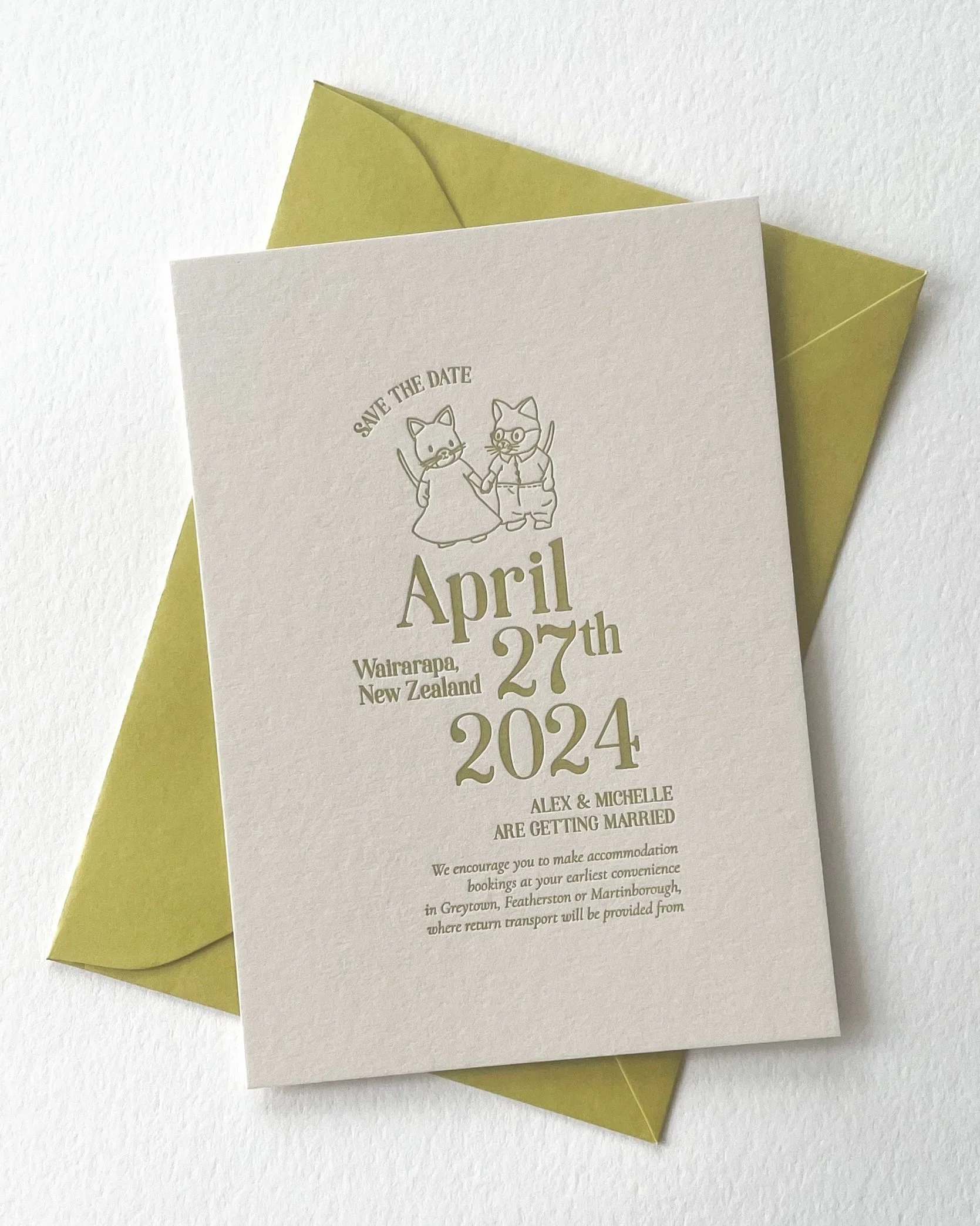 Save the Dates for wedding in Martinborough, New Zealand. Cream cardstock with mustard lettering laid on top of mustard yellow envelope. Save the Date design features Sylvanian family mice.