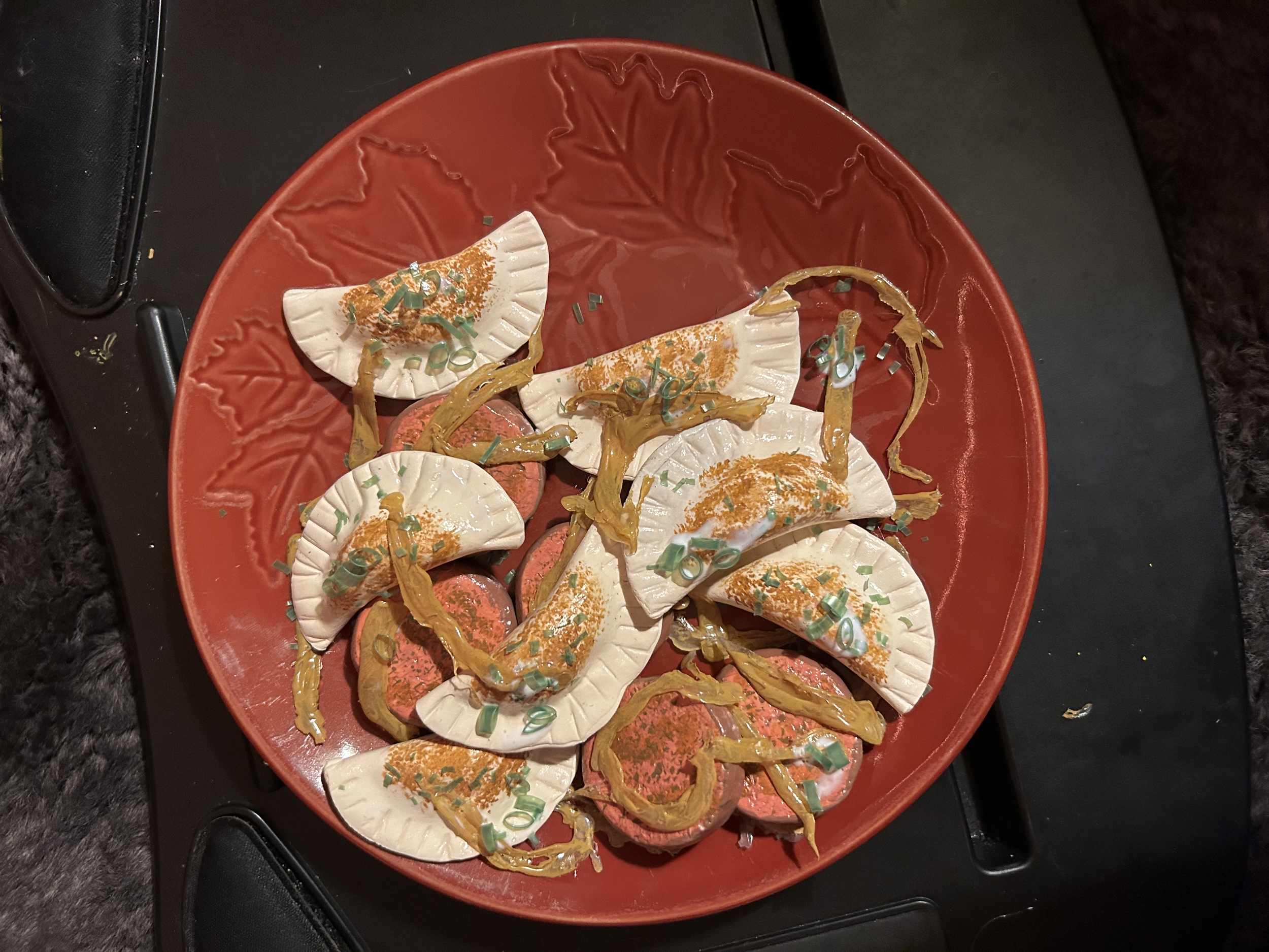 Scenery/Props 2023, Potluck Project. Pierogies with Polish kielbasa, fried onions, and topped with green onion.