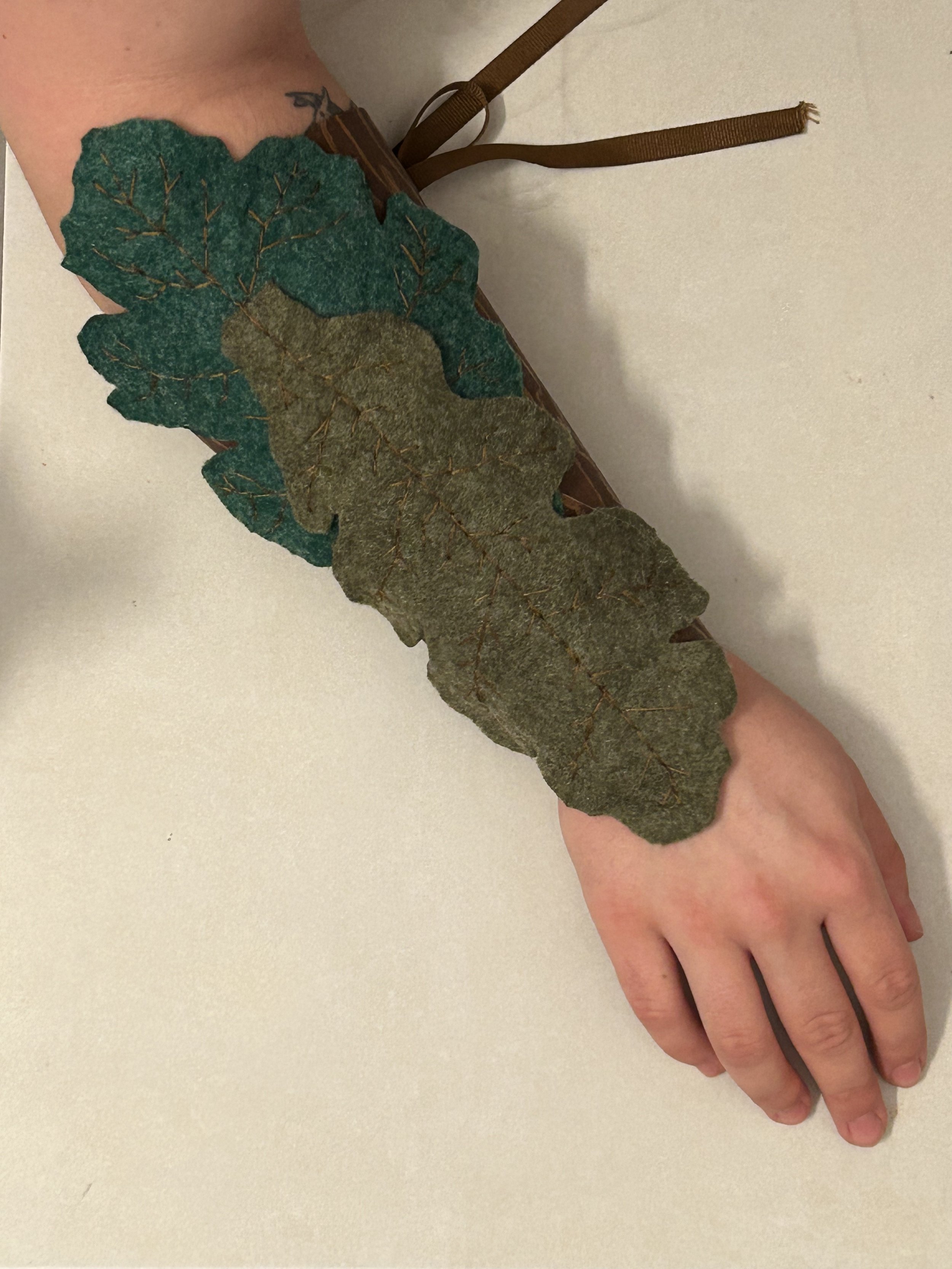 Crafts in Costumes & Props 2024, Thermal plastics project. Final bracer with Fosshape leaves sewn on. I added a fabric liner to prevent chafing.