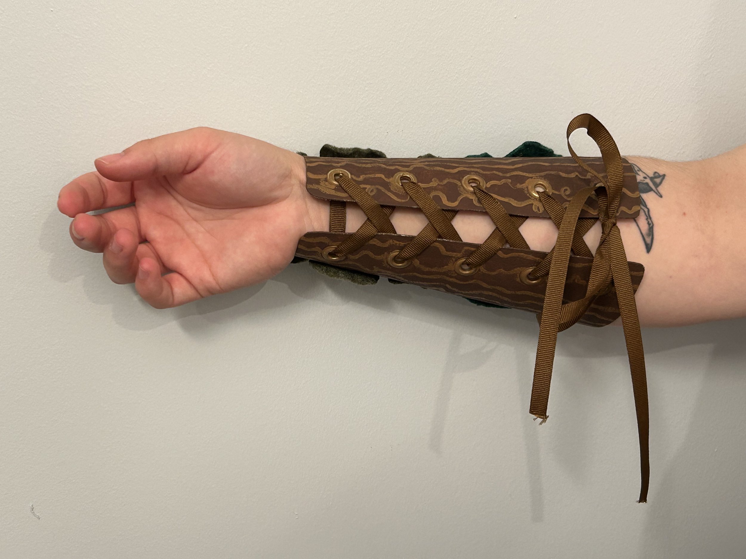 Crafts in Costumes & Props 2024, Thermal plastics project. Finished bracer closures are made with grommets and ribbon.