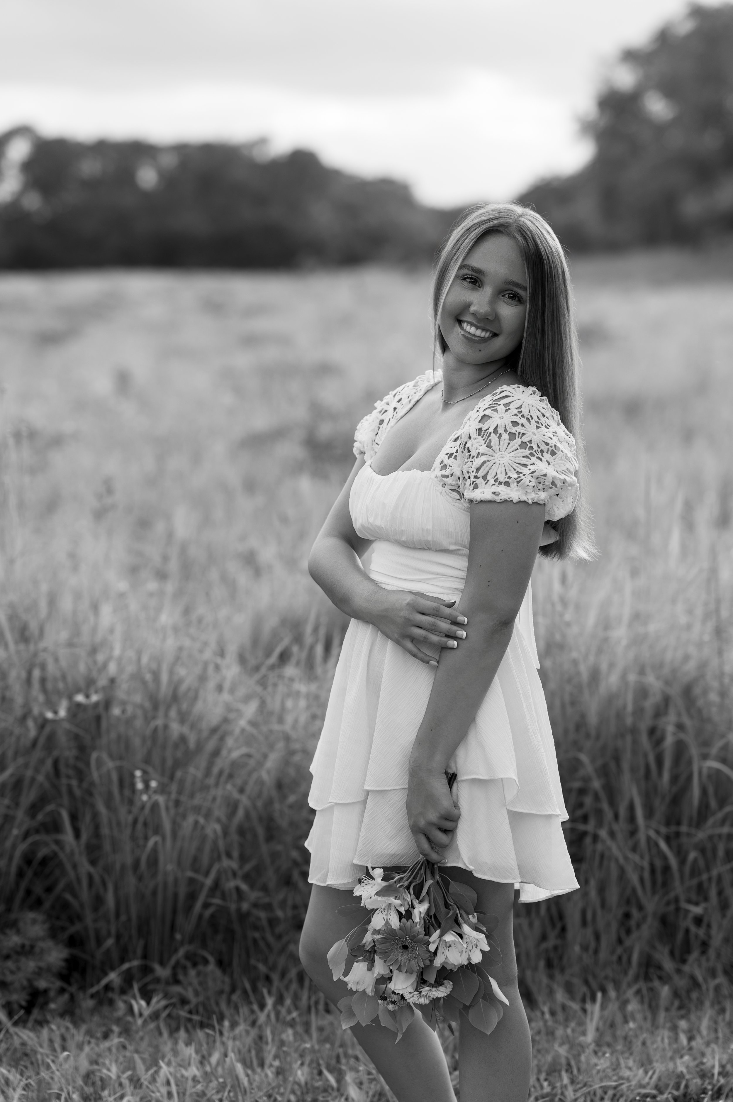 Smiling senior ready to book senior portrait session in Janesville, WI