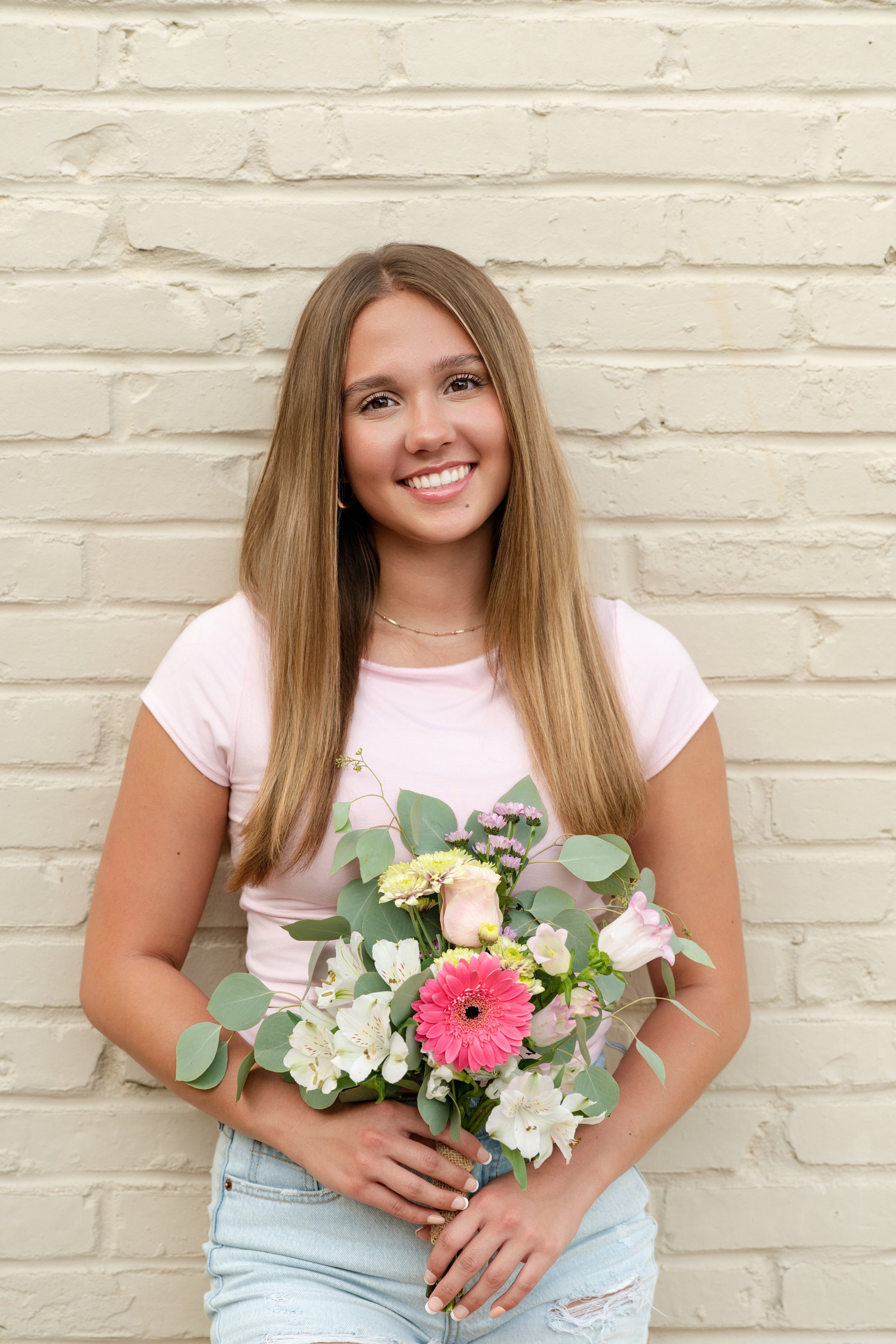 High school senior smiling during outdoor senior portrait session in Janesville, WI