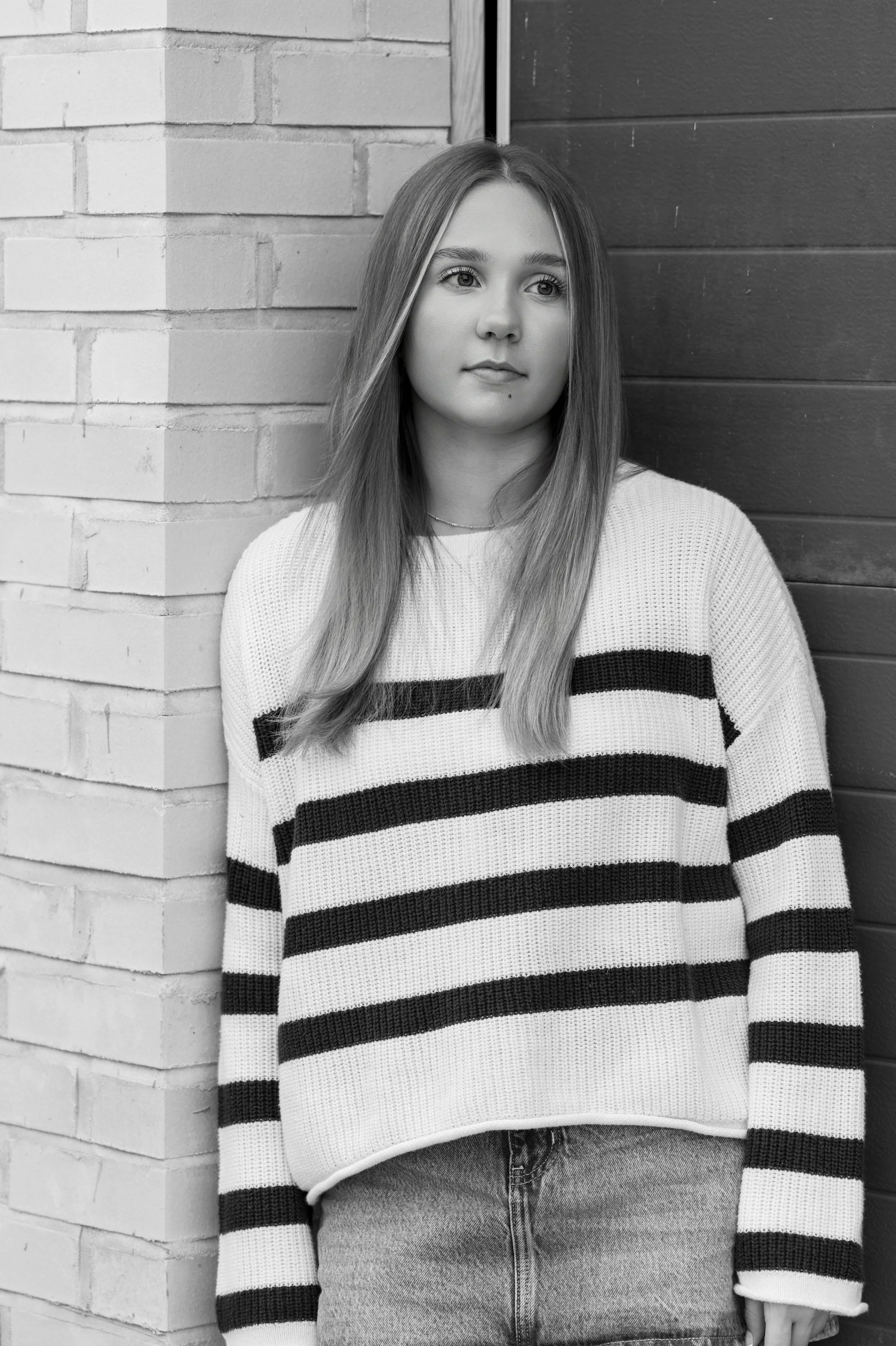 black and white photo of a teen girl posing in downtown Janesville, Wisconsin