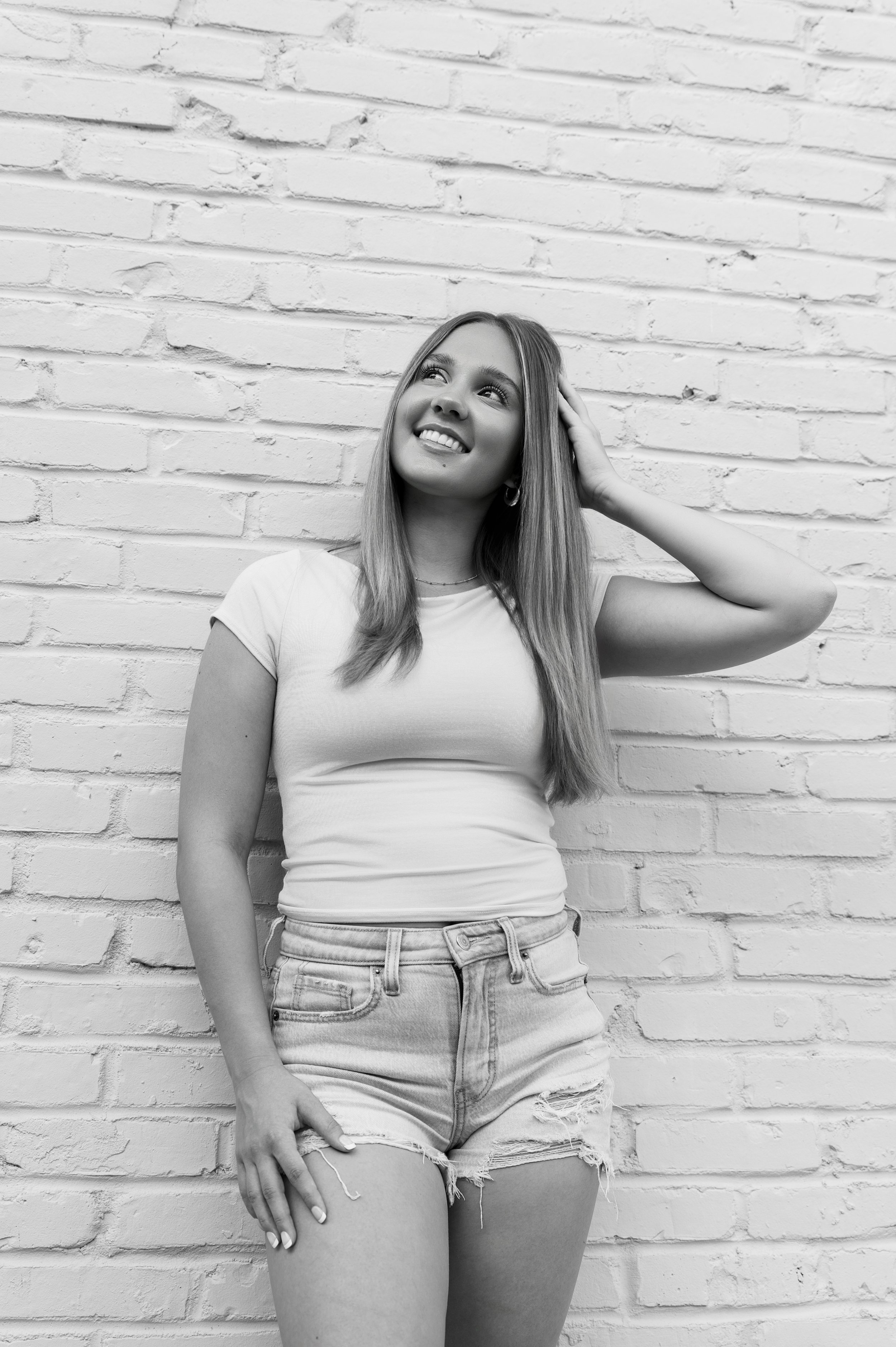 Creative black and white portrait of a Craig High School teen girl posing during a senior portrait session in Janesville, WI