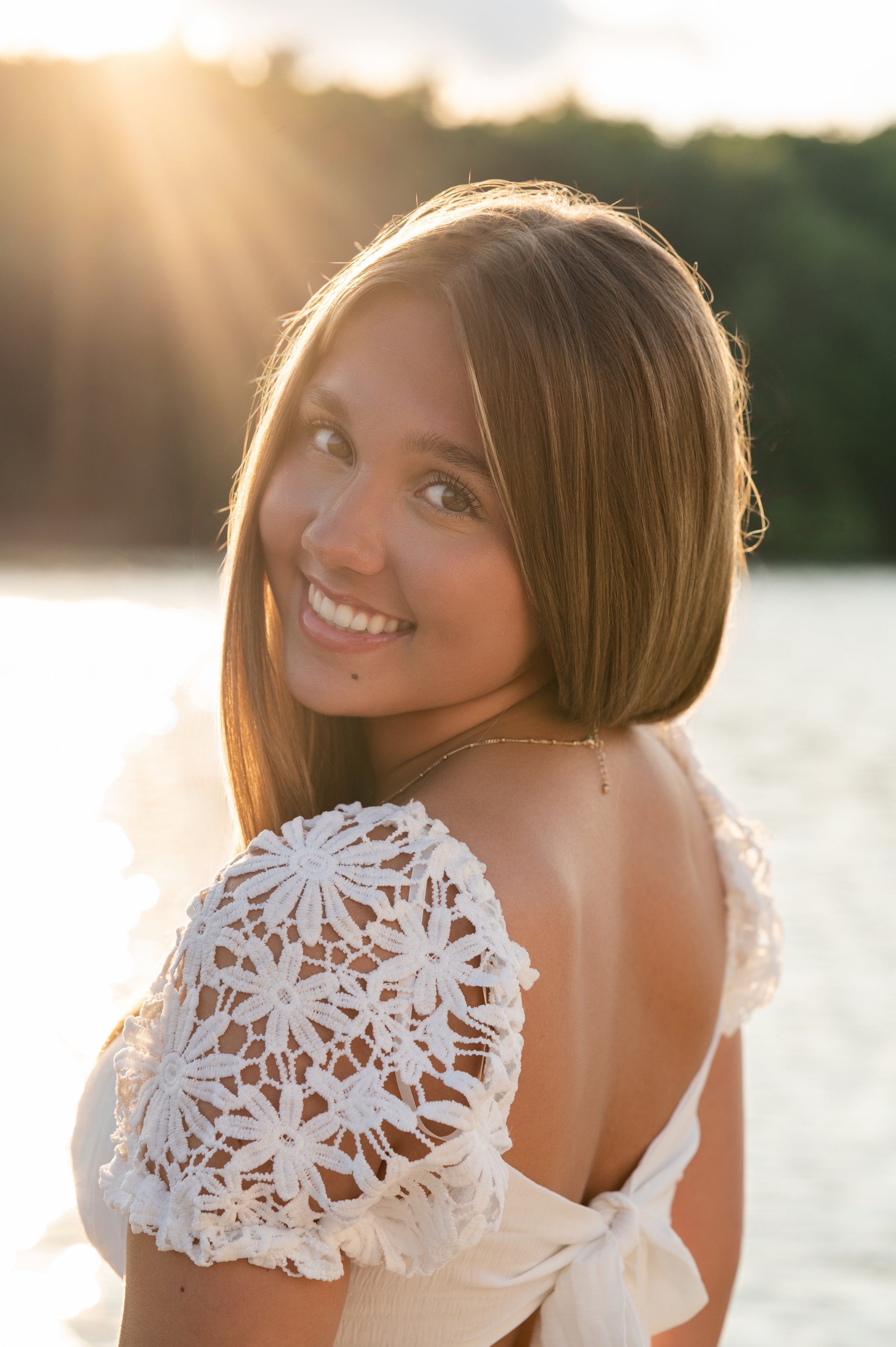 Candid senior portrait of teen smiling during golden hour senior portrait session in Janesville, WI
