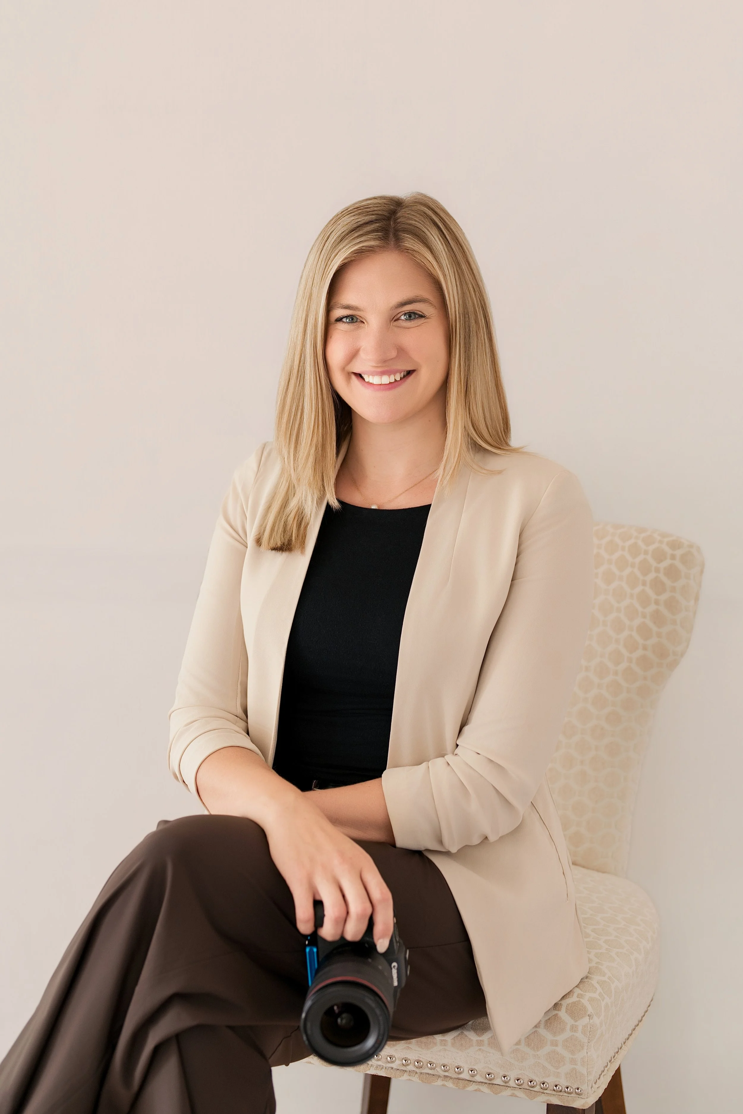 branding session sitting on a chair against a white wall in Fort Atkinson, Wisconsin