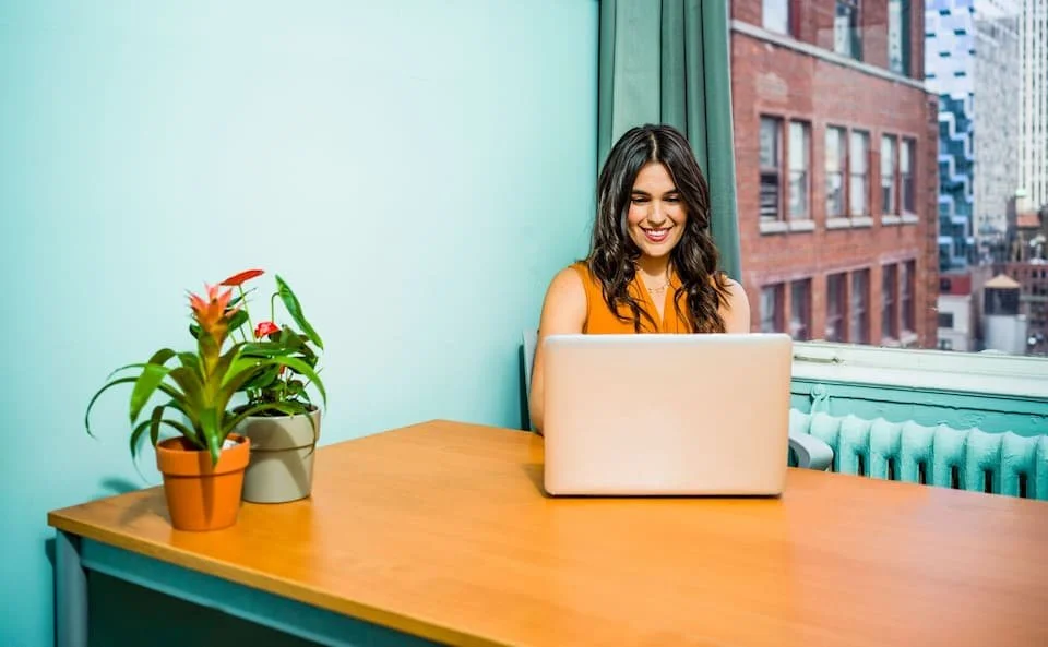 Woman sitting at her computer smiling
