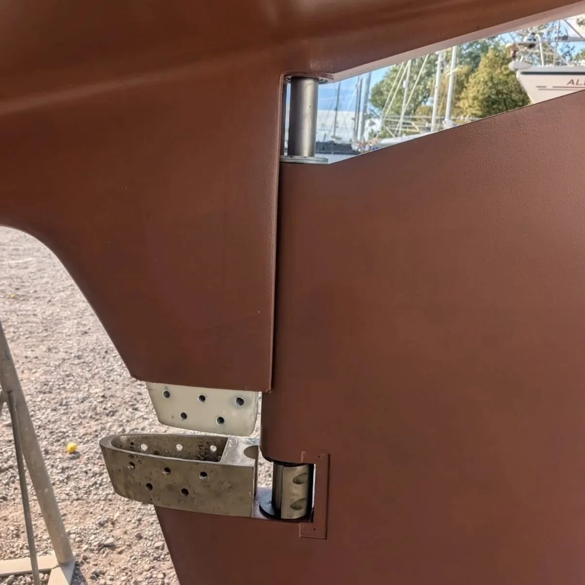 Re-installing cleaned up bronze rudder fitting. Held in place with copper rivets