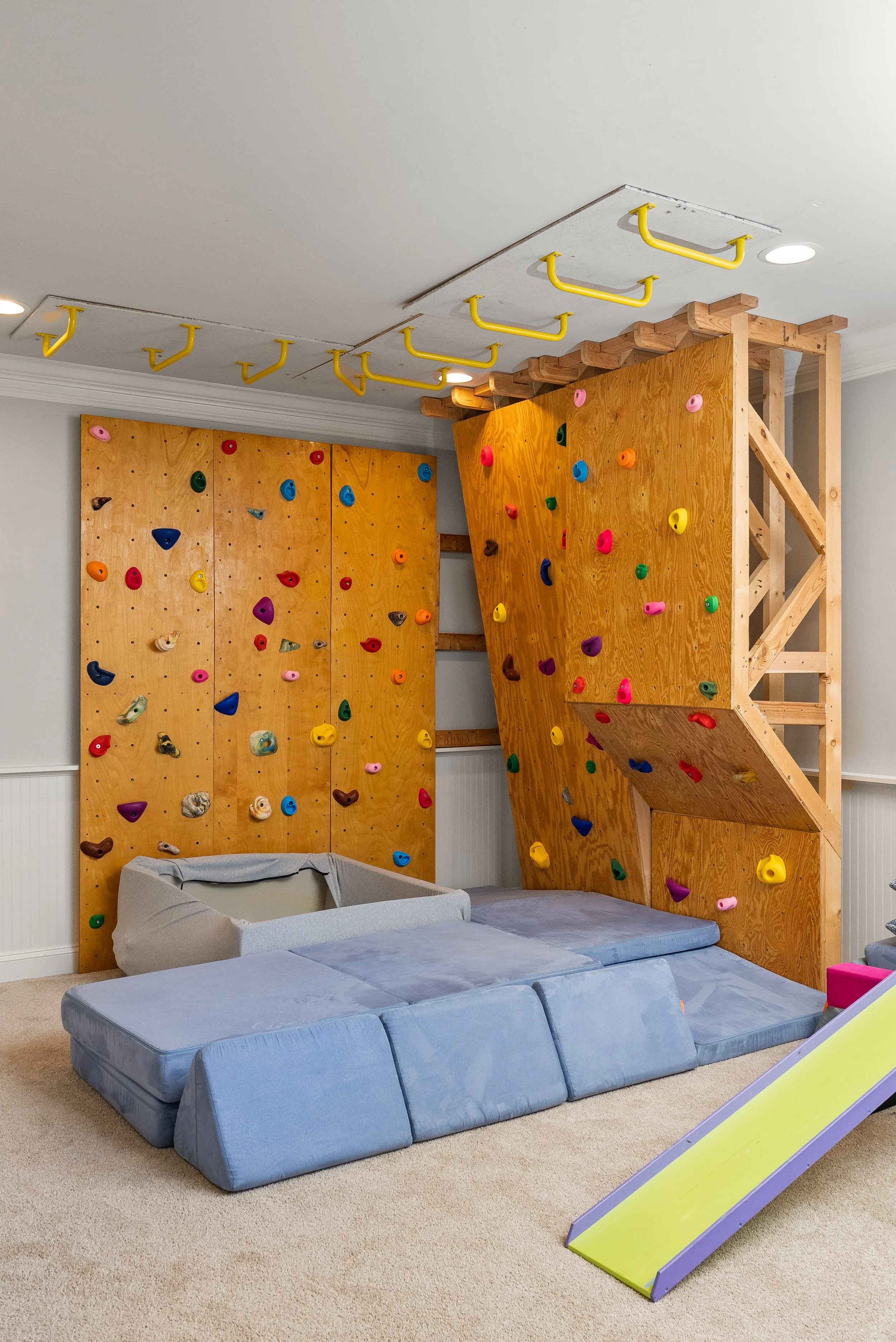 Playroom with a rock wall and slide