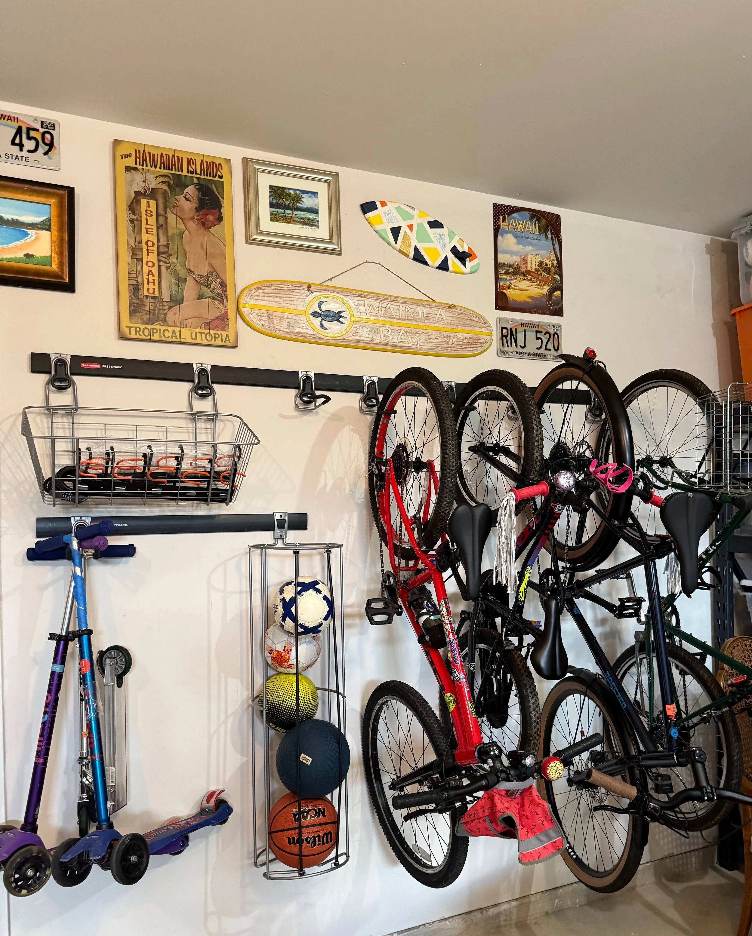 Organized family garage featuring Rubbermaid FastTrack storage for kids' toys, sports equipment, and outdoor gear